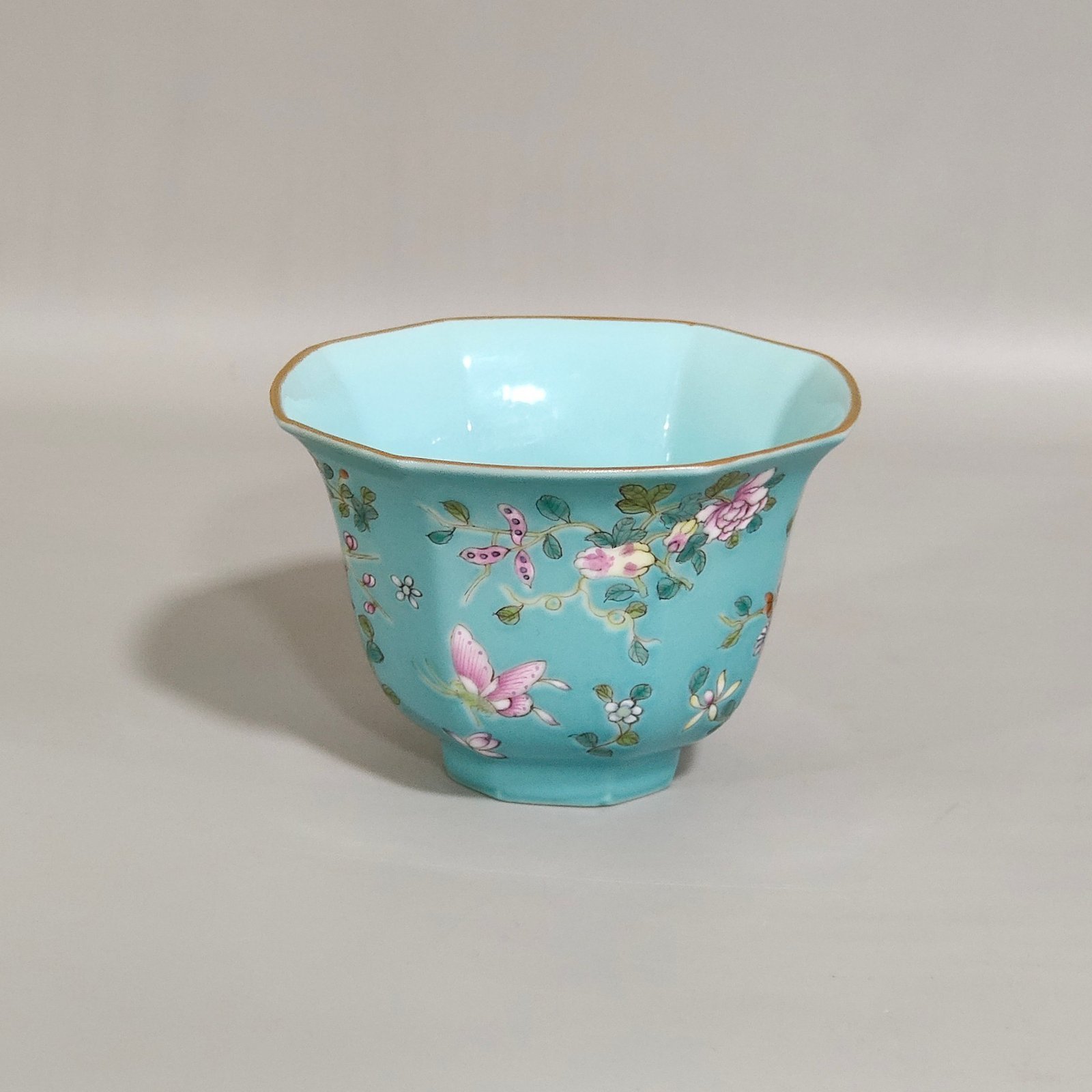 Qing Dynasty Qianlong turquoise green branched flowers and three more butterflies octagonal cup