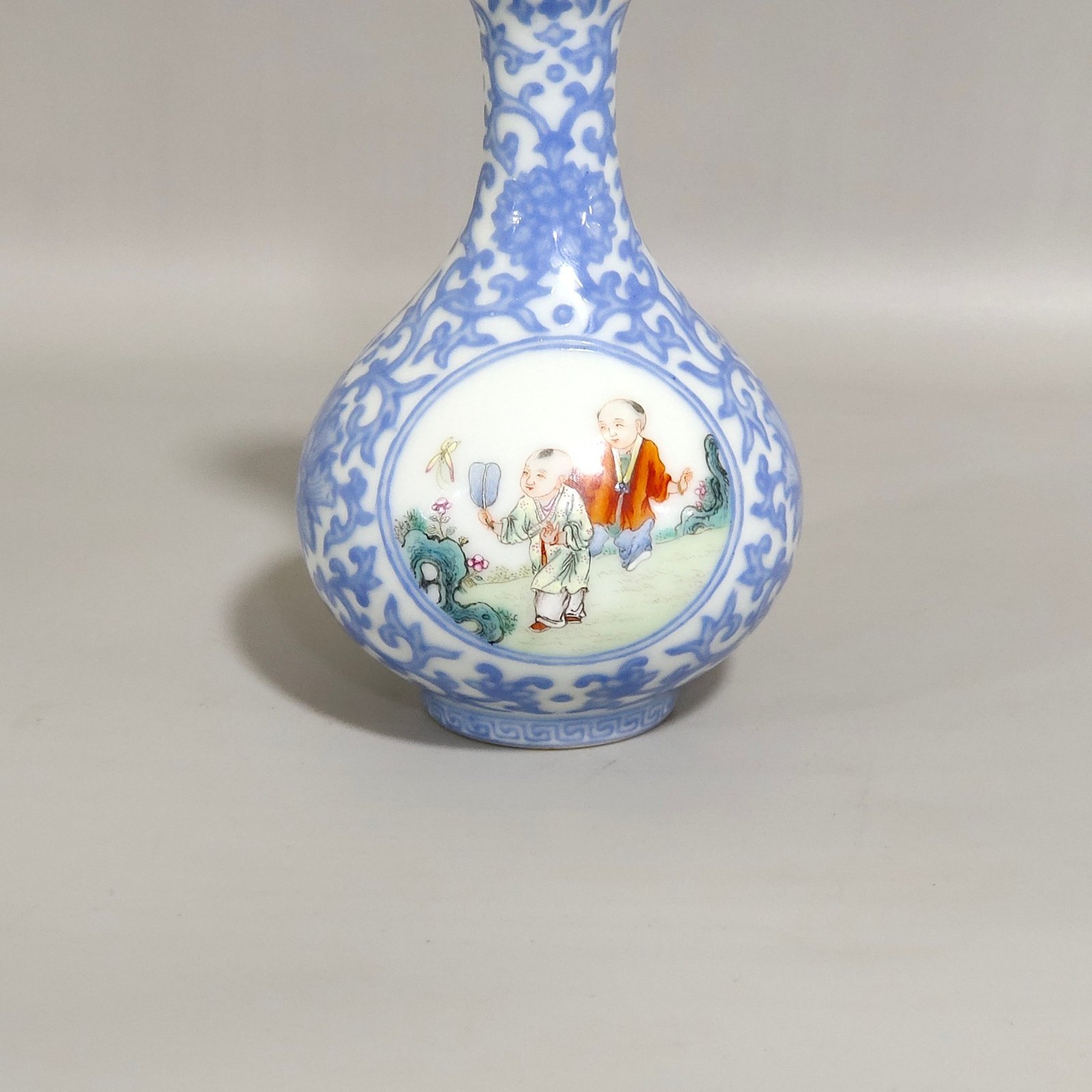 Qing Dynasty Qianlong enamel emerald blue windowed boy’s vase