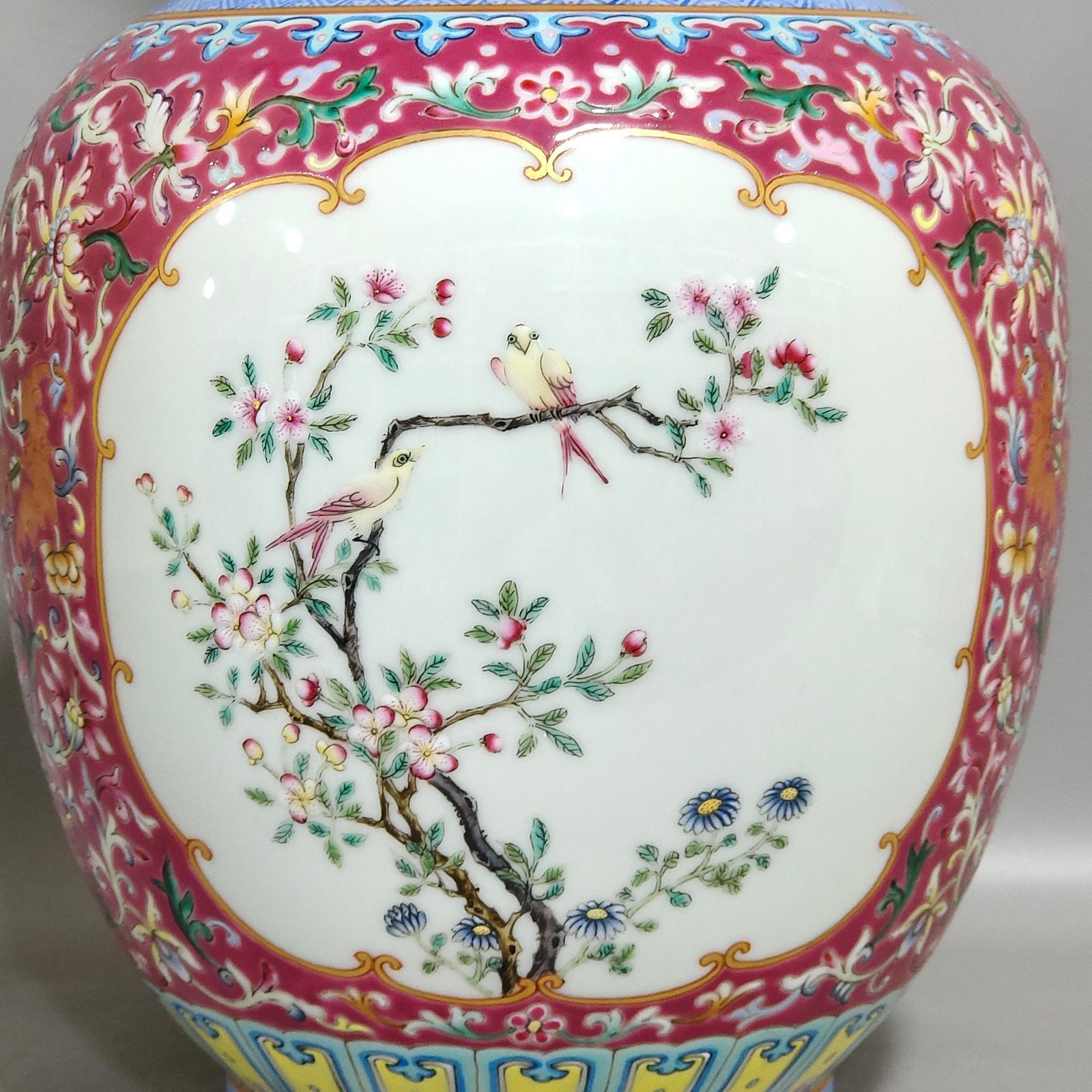 Qing Dynasty Qianlong rouge ground windowed flower and bird amphorae