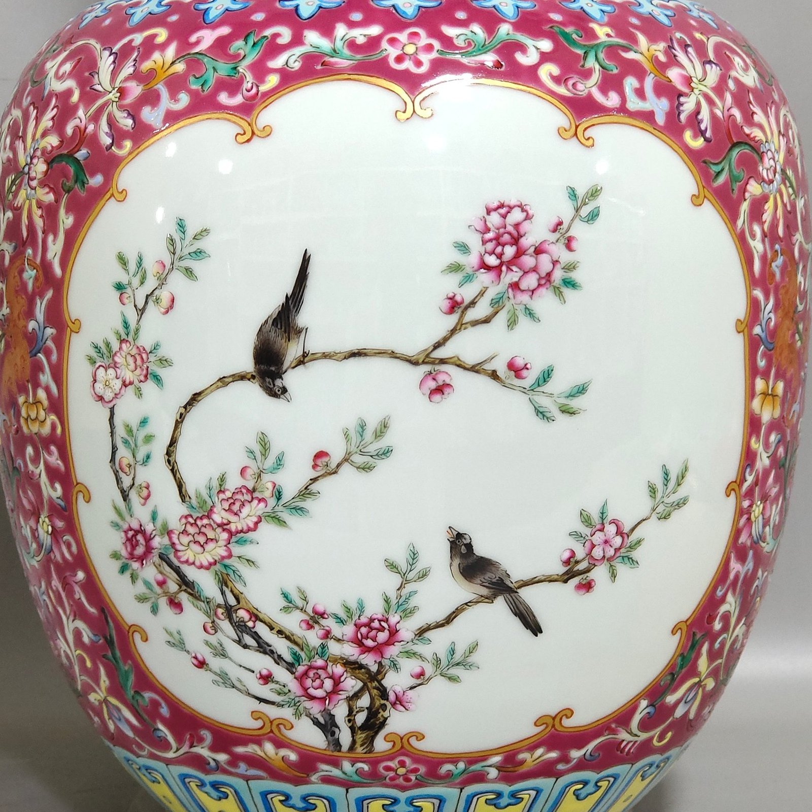 Qing Dynasty Qianlong rouge ground windowed flower and bird amphorae