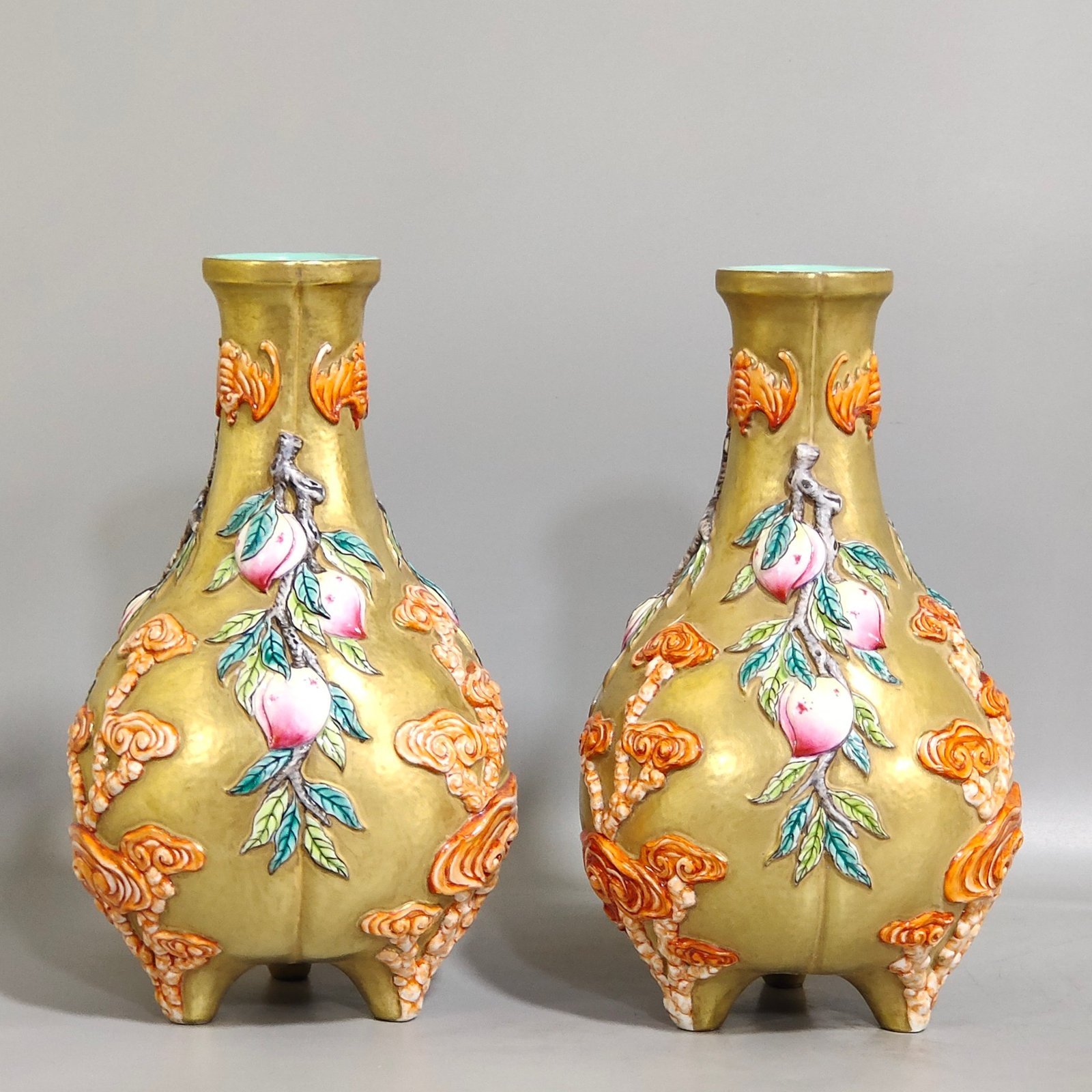 Qing Dynasty Qianlong gold relief three legged bottle of longevity peach and Ganoderma lucidum