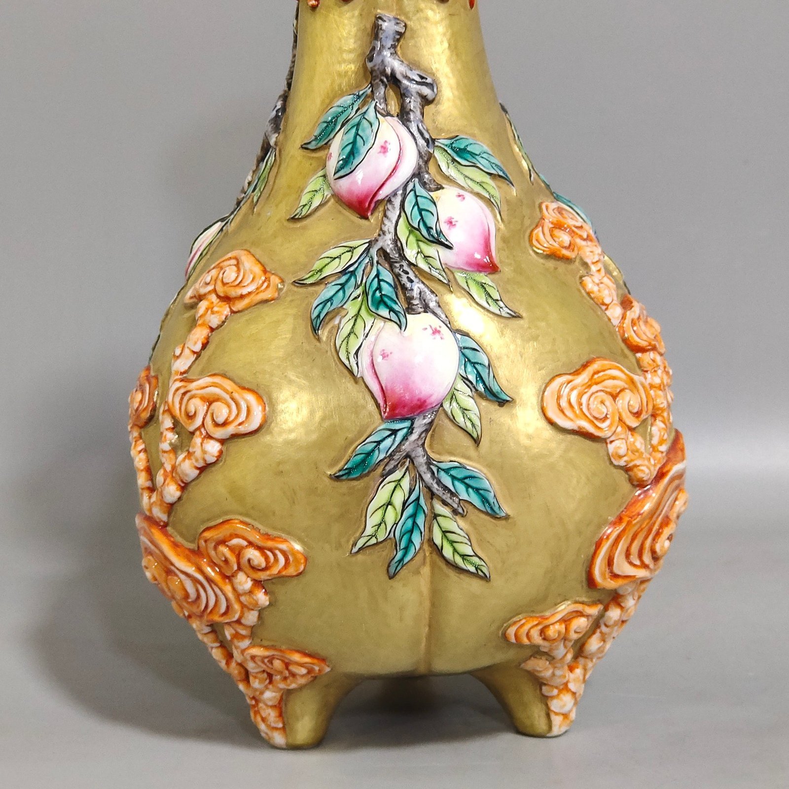 Qing Dynasty Qianlong gold relief three legged bottle of longevity peach and Ganoderma lucidum