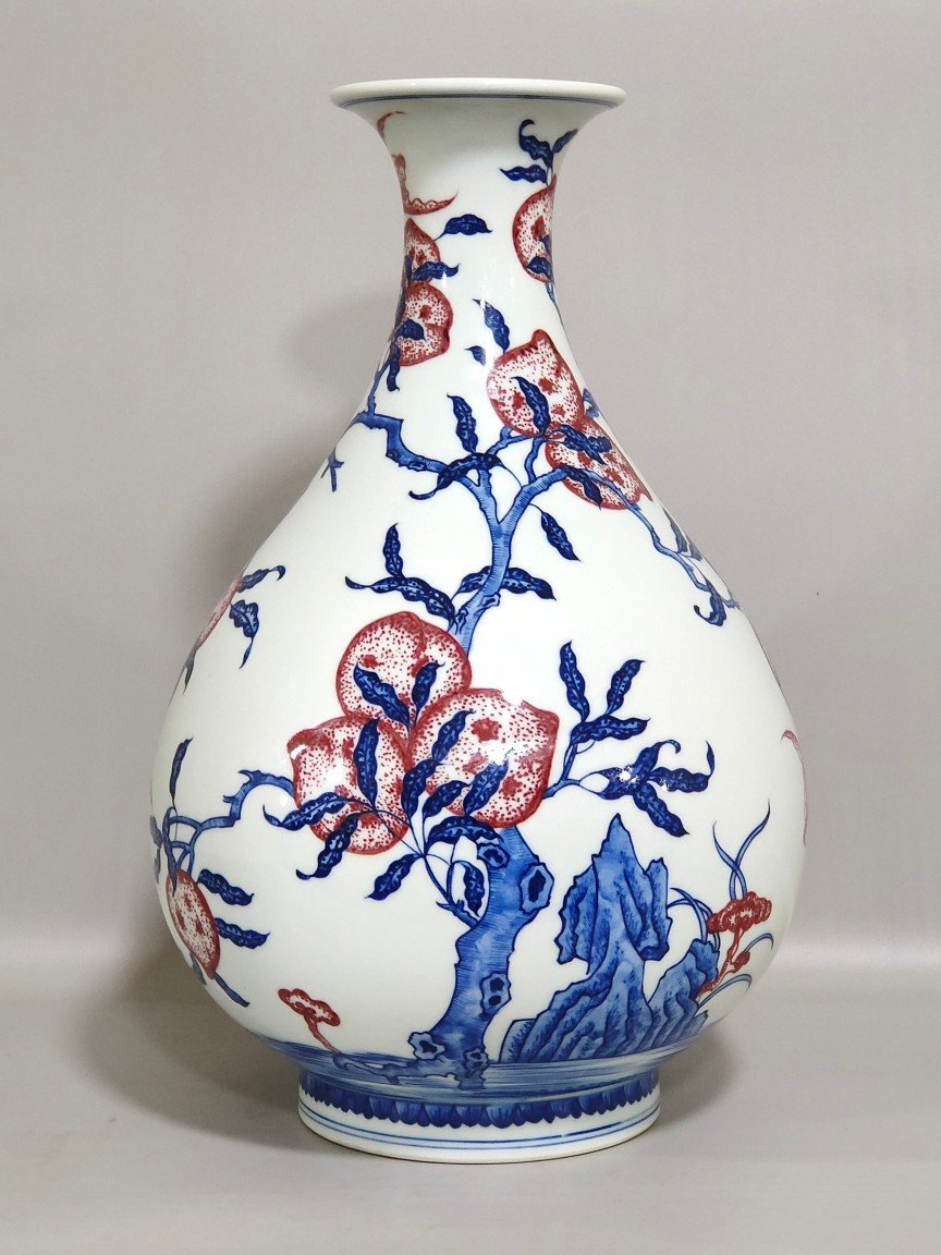 Qing Dynasty Qianlong blue and white underglaze red Nine Peach spring vase