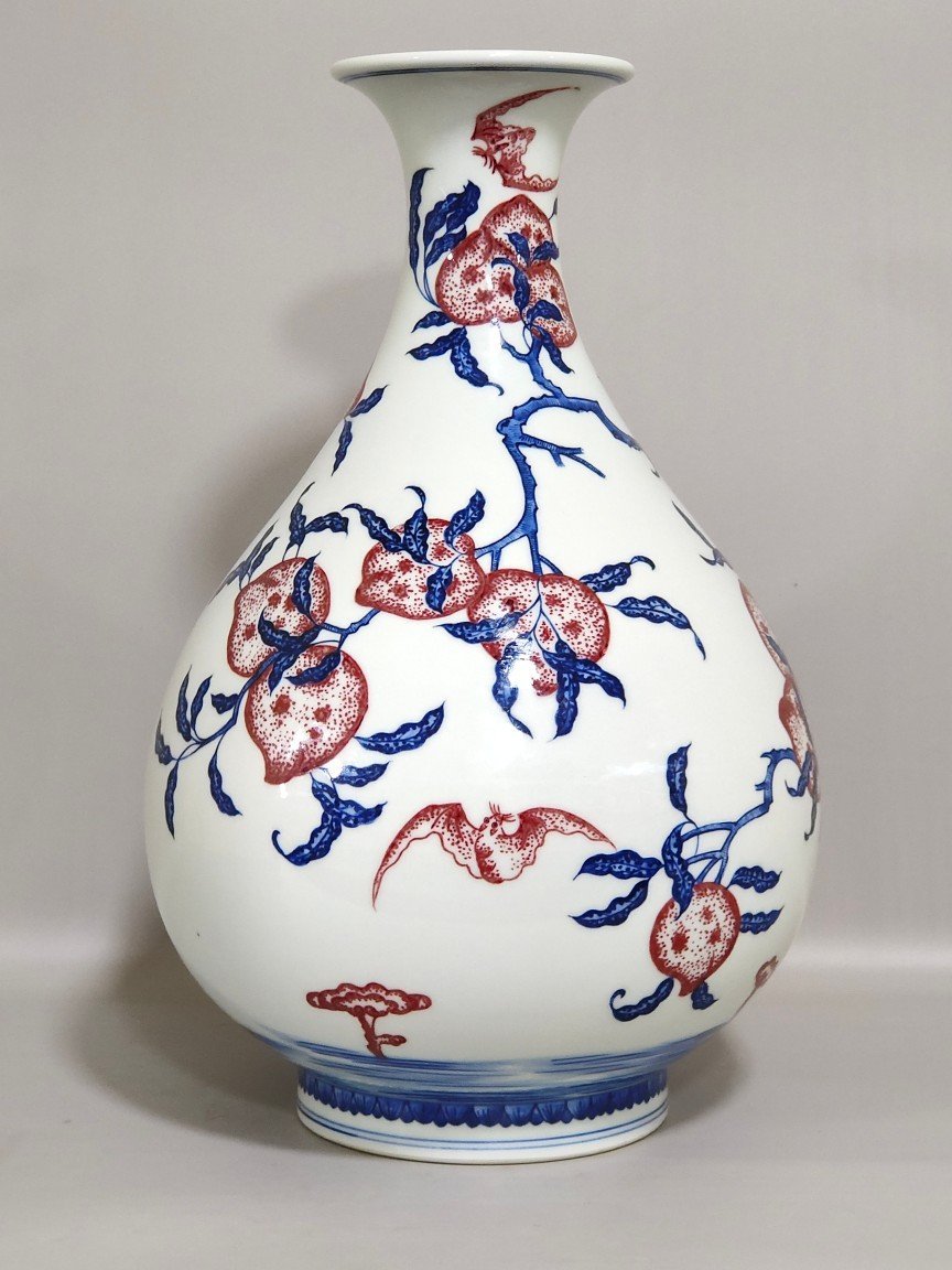 Qing Dynasty Qianlong blue and white underglaze red Nine Peach spring vase