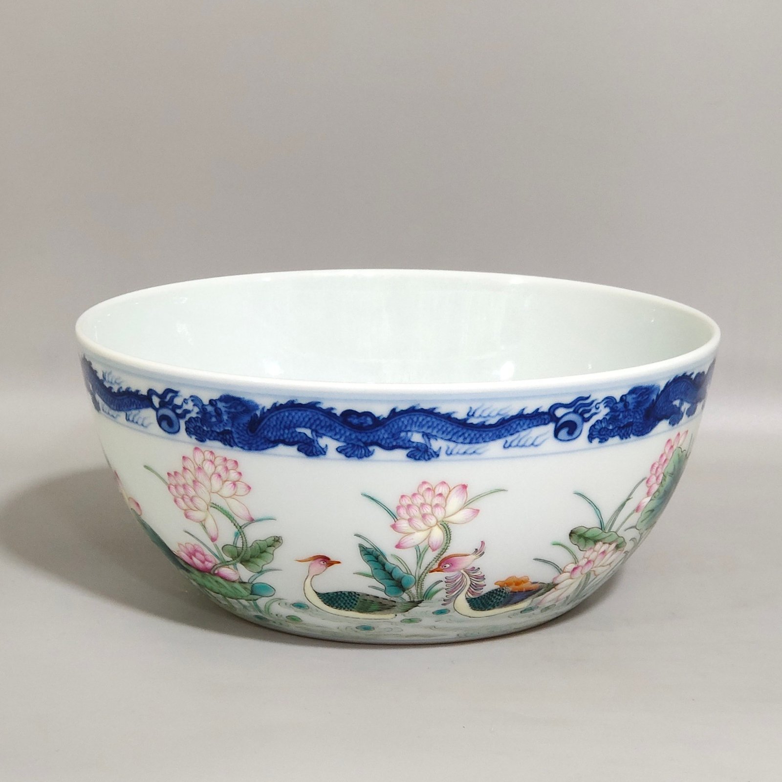 Qing Dynasty Qianlong blue and white dragon-patterned lotus bowl with mandarin ducks