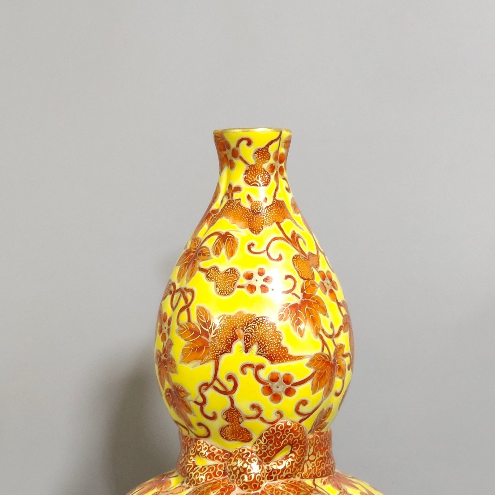 Qing Dynasty Qianlong yellow glaze painted gold-plated gourd vase