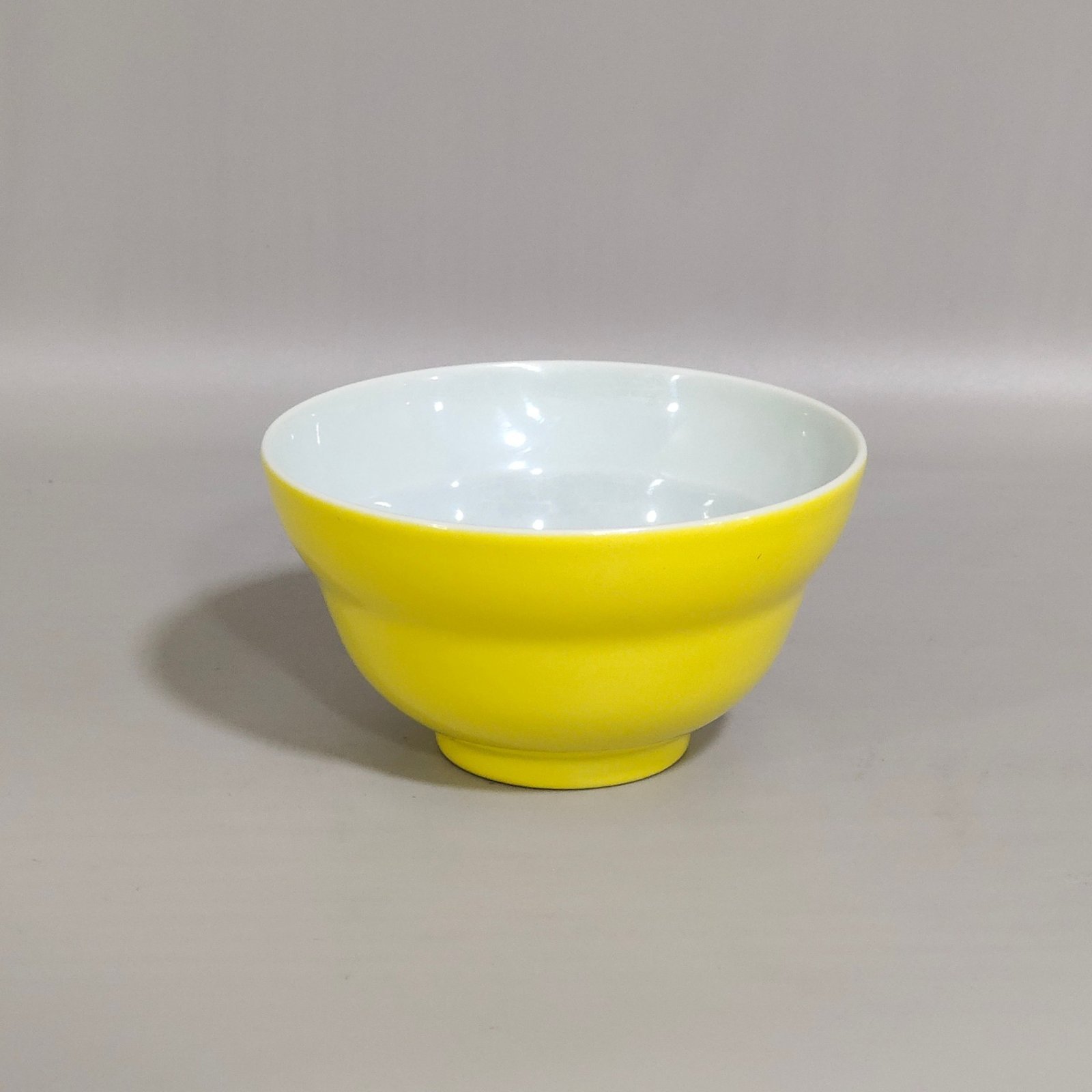Qing Dynasty Yongzheng lemon yellow glaze folding cup with interior painting