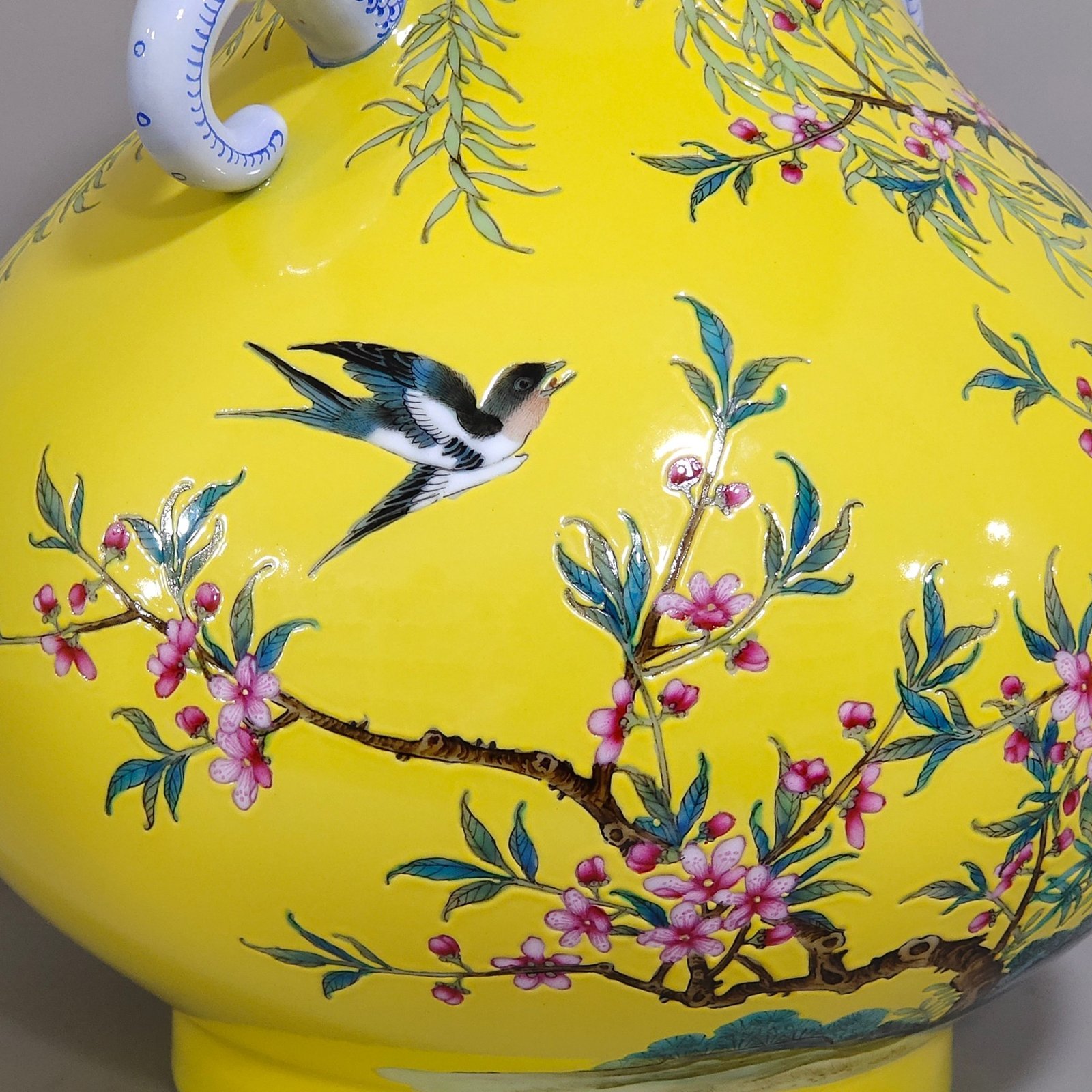 Qing Dynasty Yongzheng lemon yellow glazed willow swallow elephant ear vase