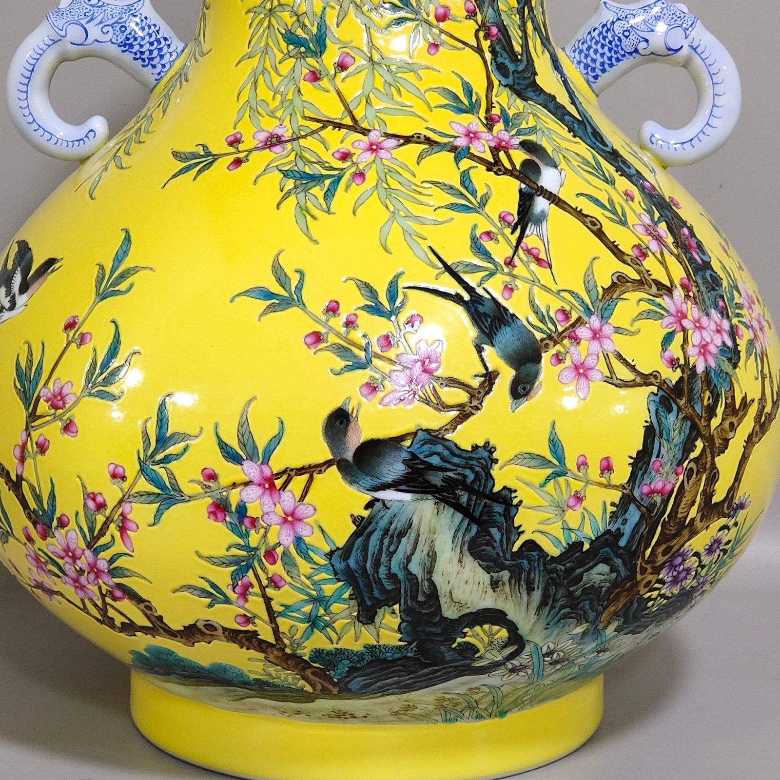 Qing Dynasty Yongzheng lemon yellow glazed willow swallow elephant ear vase