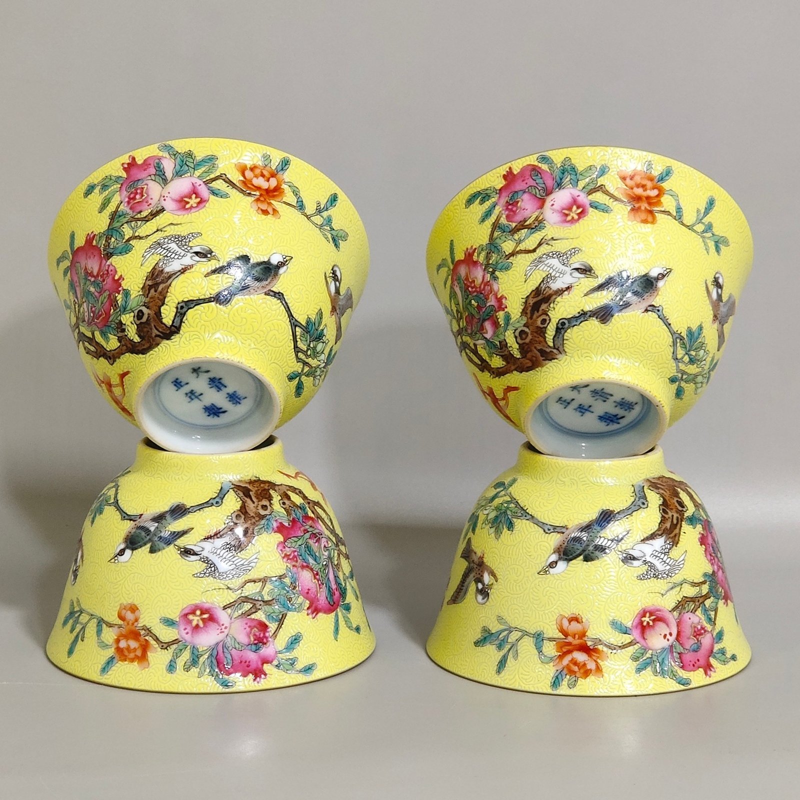Qing Dynasty Yongzheng pink pomegranate flower and bird inscribed cup