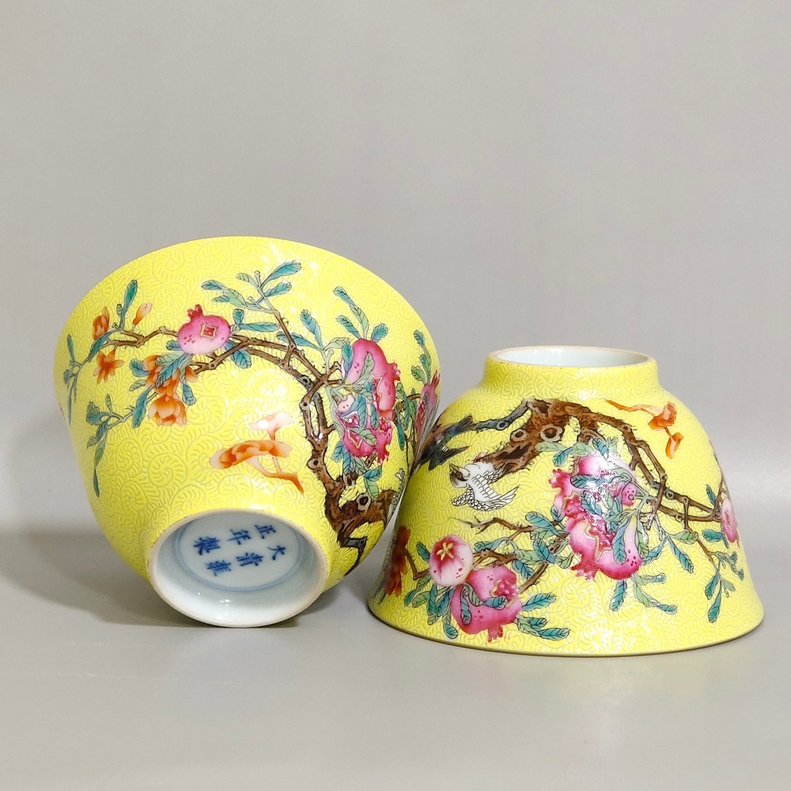 Qing Dynasty Yongzheng pink pomegranate flower and bird inscribed cup