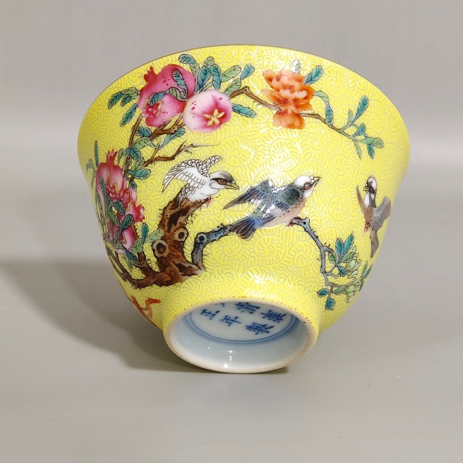 Qing Dynasty Yongzheng pink pomegranate flower and bird inscribed cup