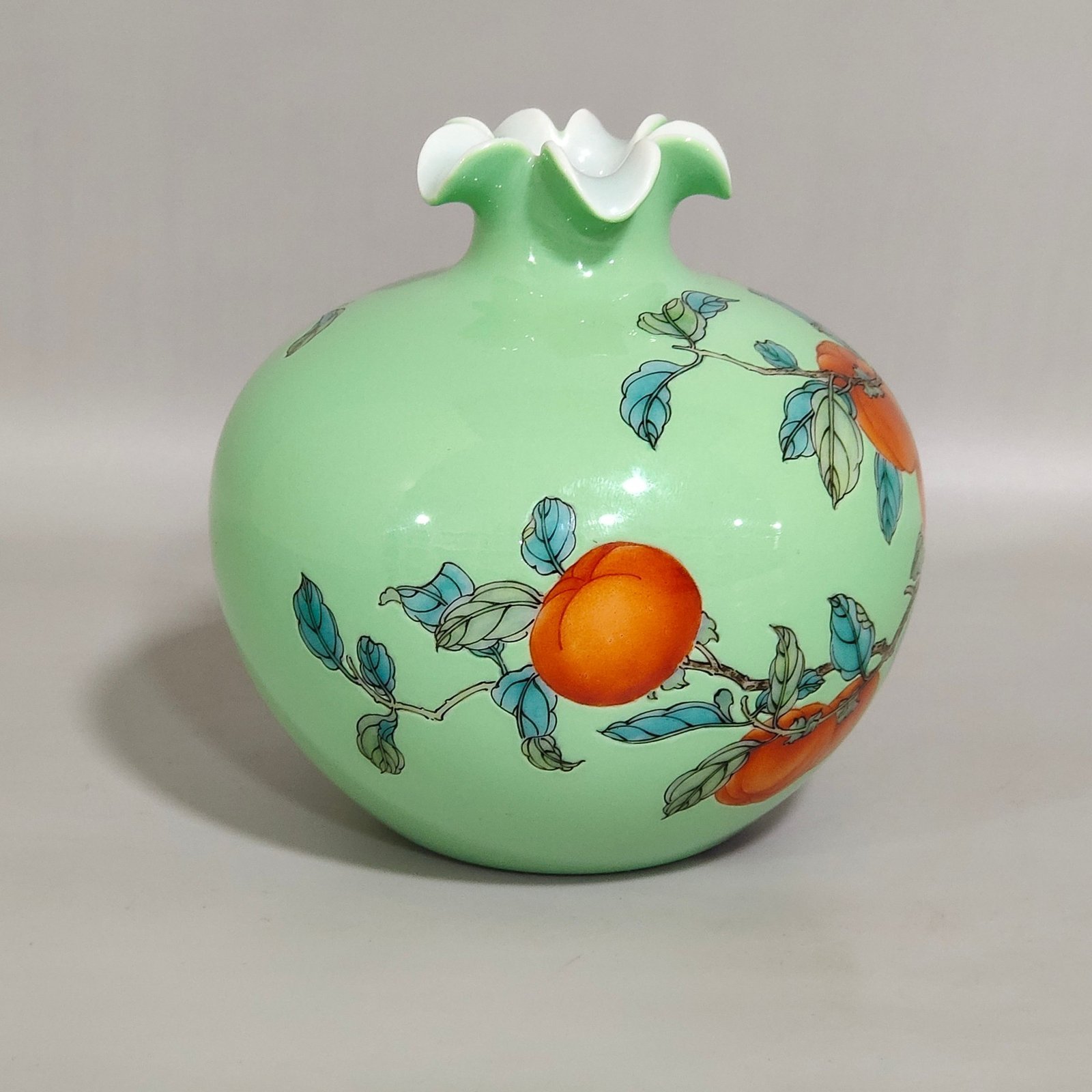 Qing Dynasty Yongzheng A green-glazed apple persimmon and pomegranate statue