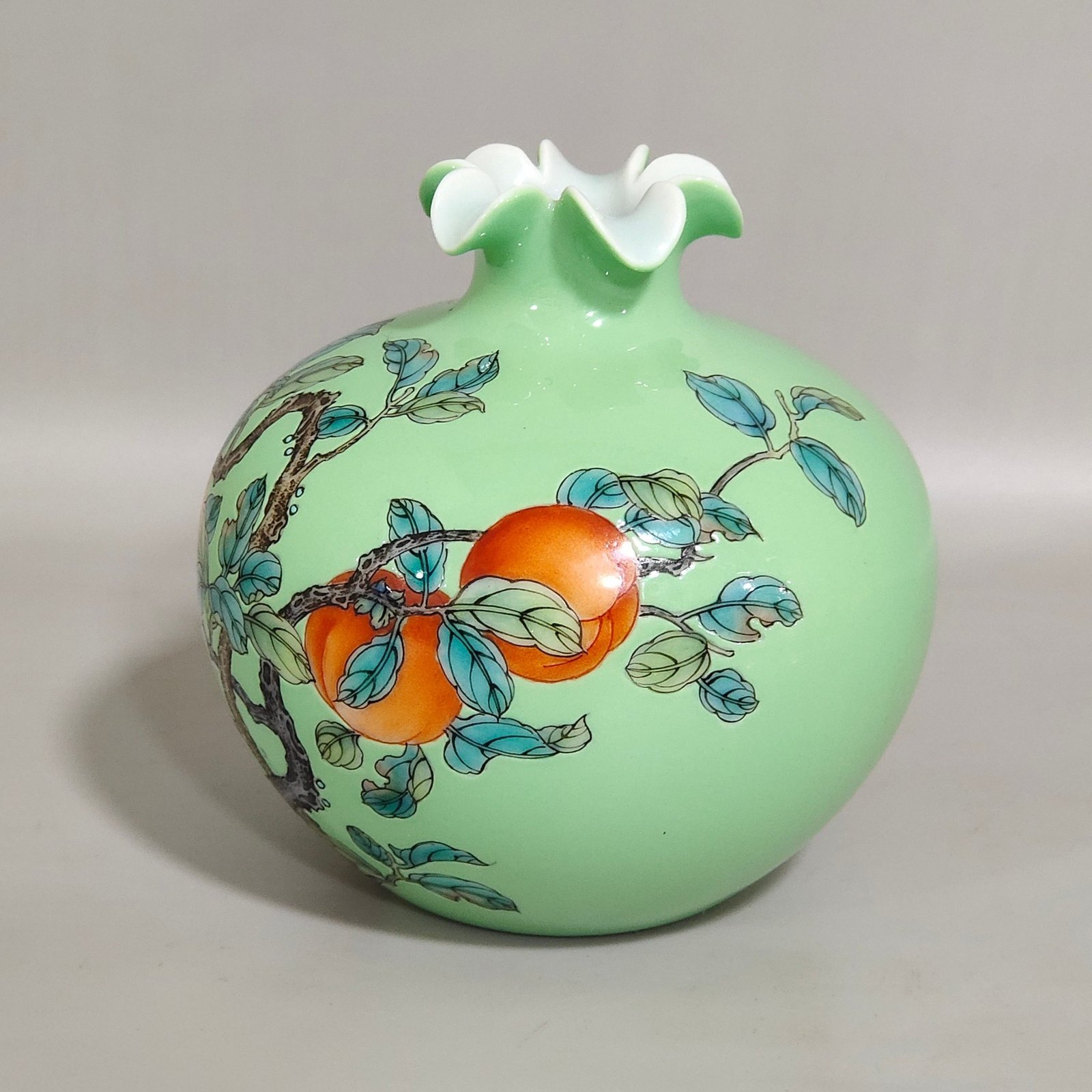 Qing Dynasty Yongzheng A green-glazed apple persimmon and pomegranate statue