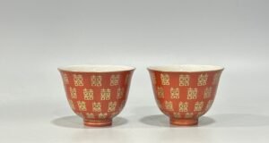 Qing Dynasty Tongzhi Pastel coral red cup with gold double happiness pattern