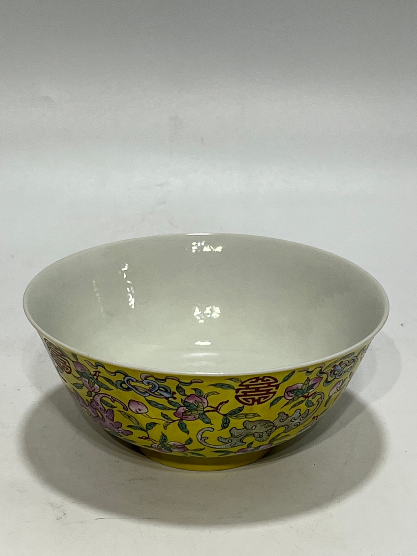 Qing Dynasty Tongzhi famille rose yellow ground longevity bowl