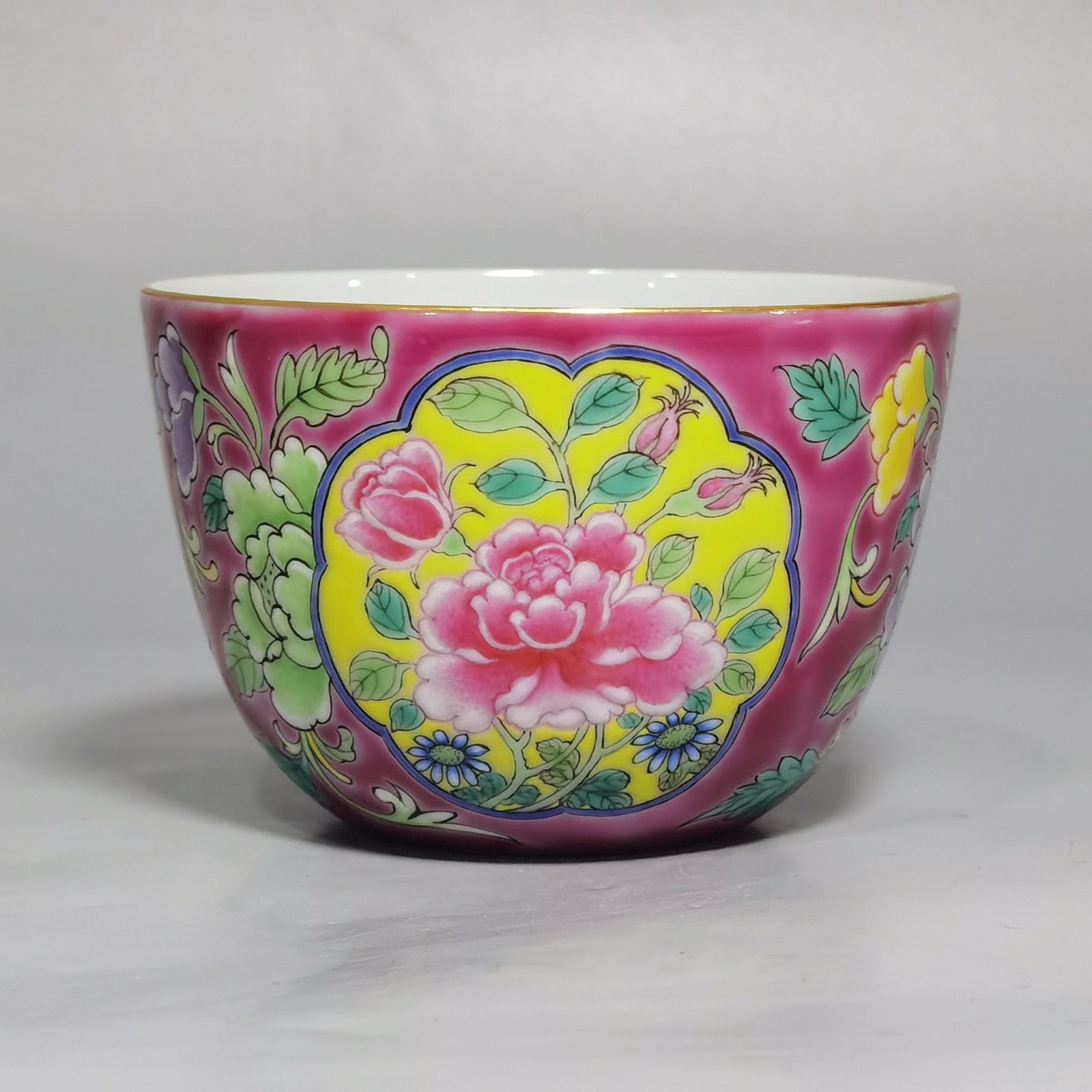 Qing Dynasty Kangxi pair of enamel and rouge ground consecrated cups with floral patterns