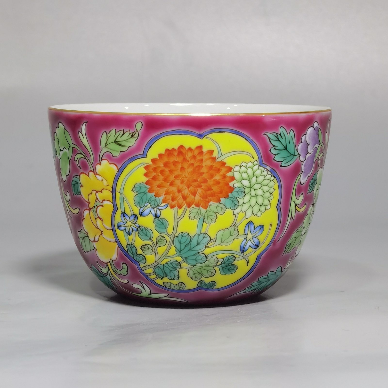 Qing Dynasty Kangxi pair of enamel and rouge ground consecrated cups with floral patterns