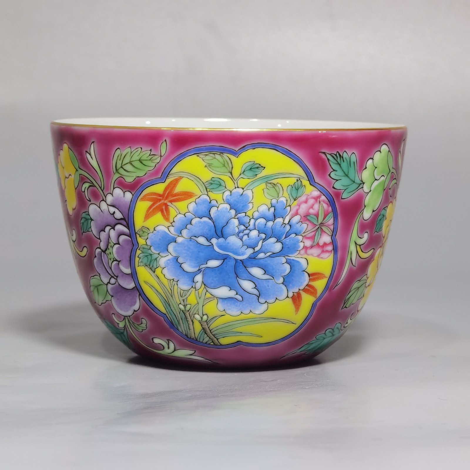 Qing Dynasty Kangxi pair of enamel and rouge ground consecrated cups with floral patterns