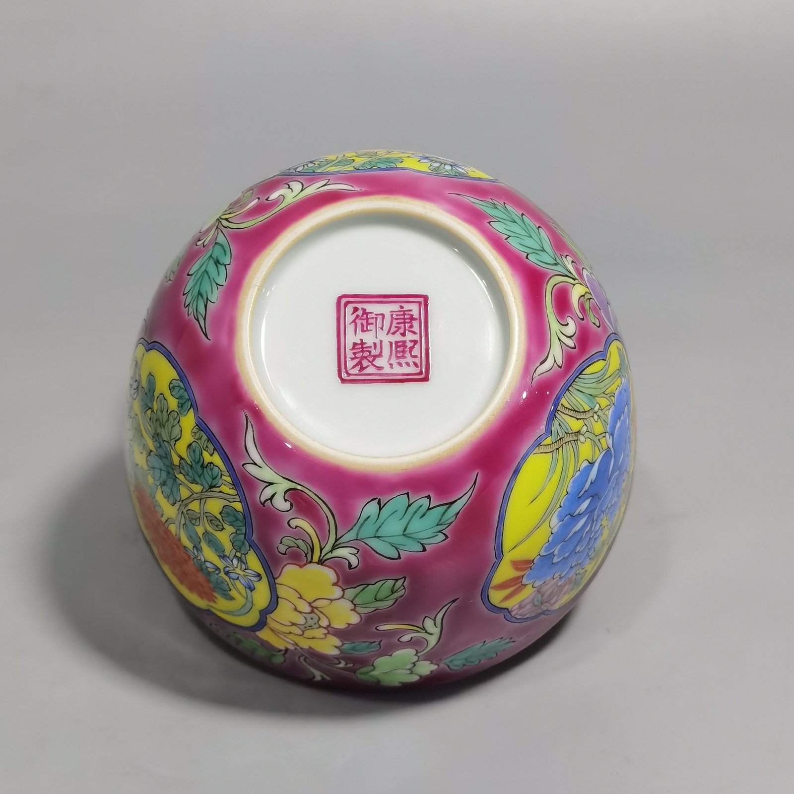Qing Dynasty Kangxi pair of enamel and rouge ground consecrated cups with floral patterns