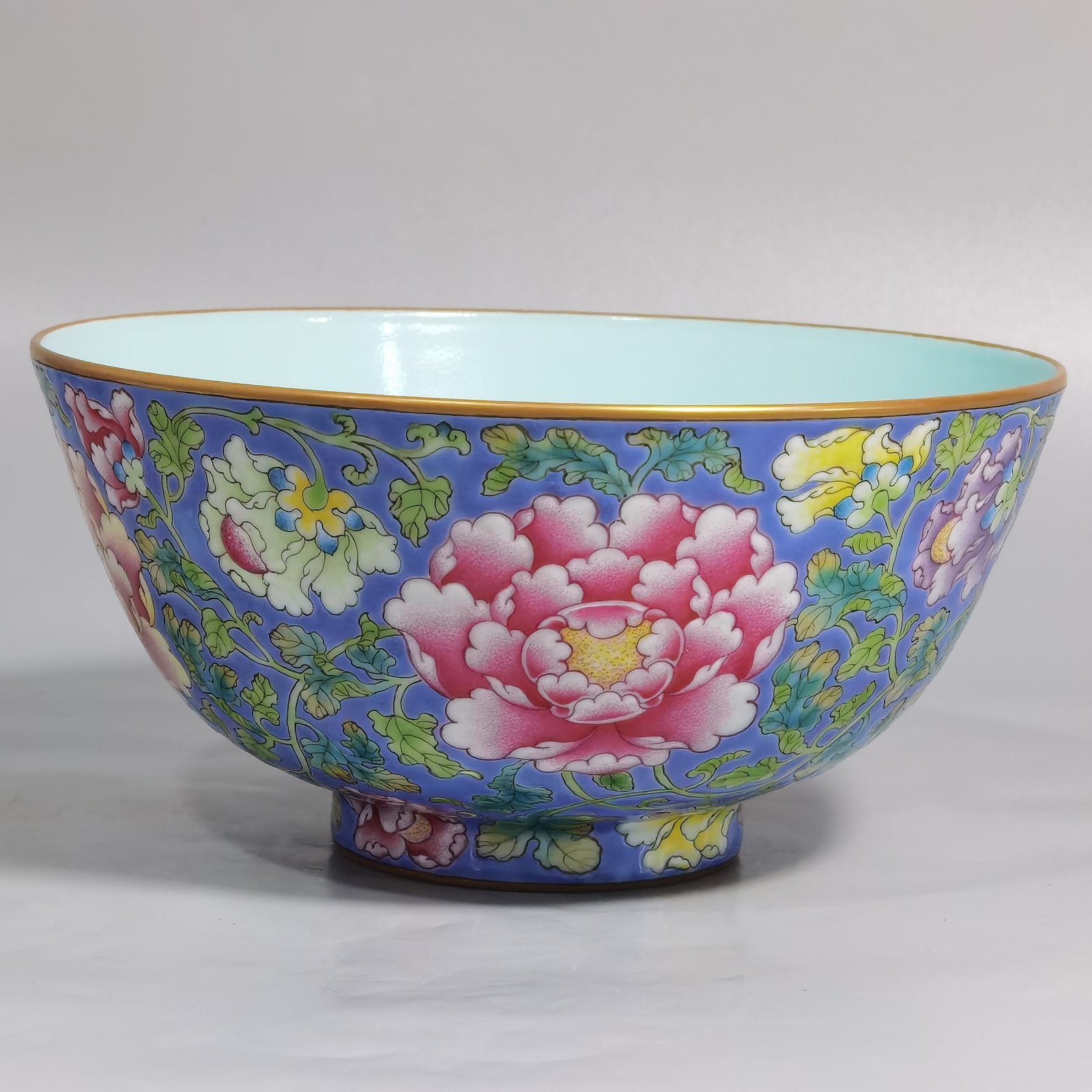 Qing Dynasty Kangxi imperial enamel blue ground lotus and peony flower bowl