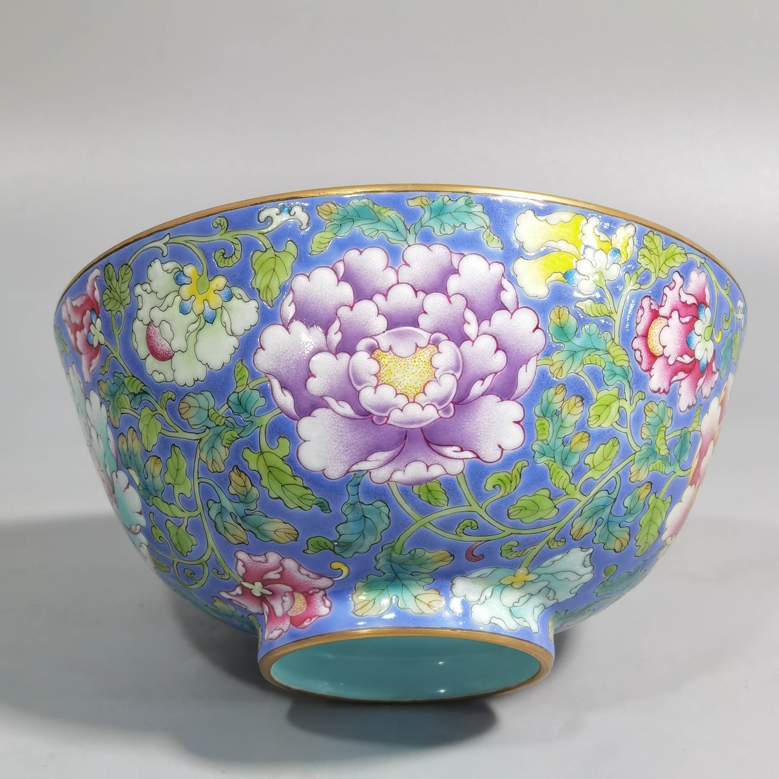Qing Dynasty Kangxi imperial enamel blue ground lotus and peony flower bowl