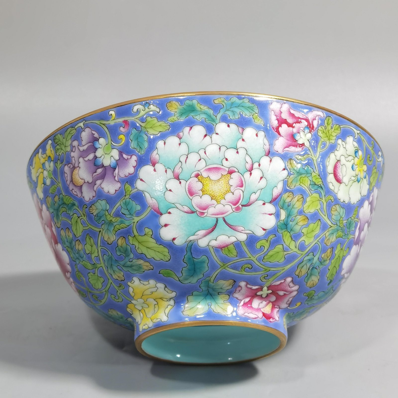 Qing Dynasty Kangxi imperial enamel blue ground lotus and peony flower bowl