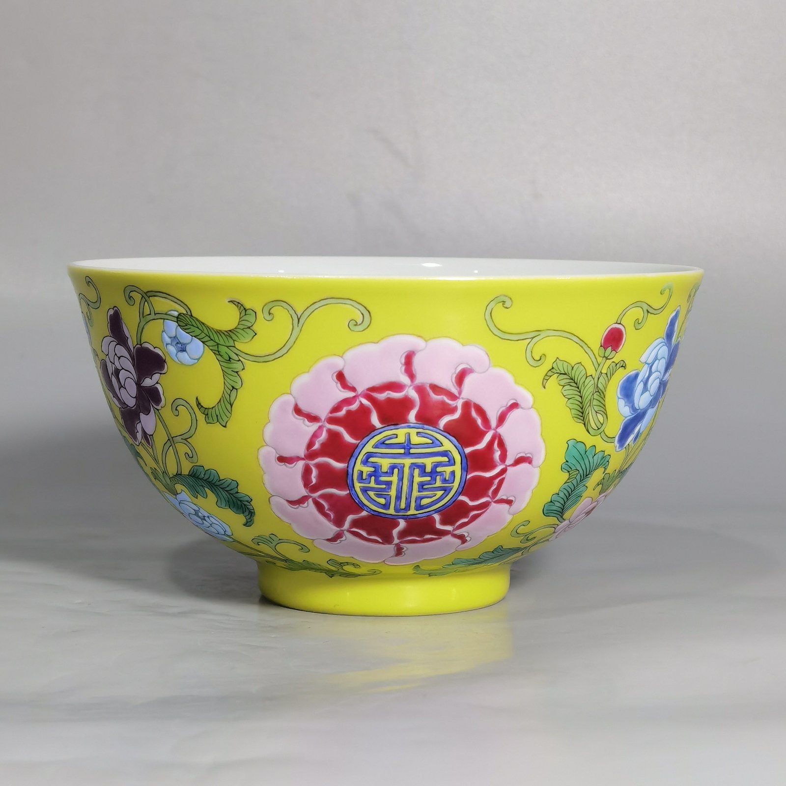 Qing Dynasty Kangxi Imperial enamel bowl with flowers and longevity characters on the ground