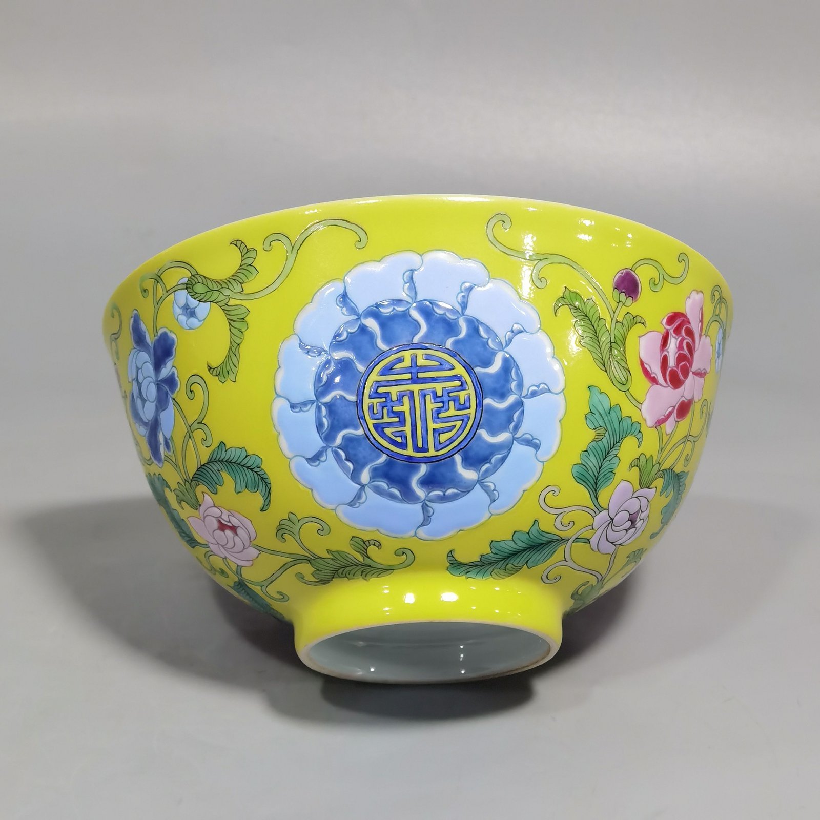 Qing Dynasty Kangxi Imperial enamel bowl with flowers and longevity characters on the ground