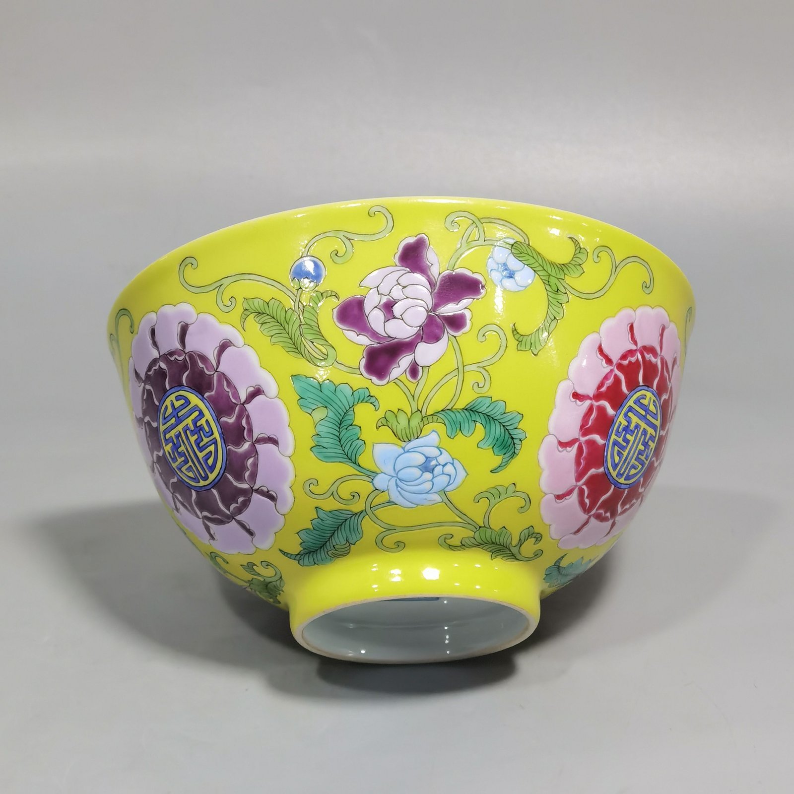Qing Dynasty Kangxi Imperial enamel bowl with flowers and longevity characters on the ground