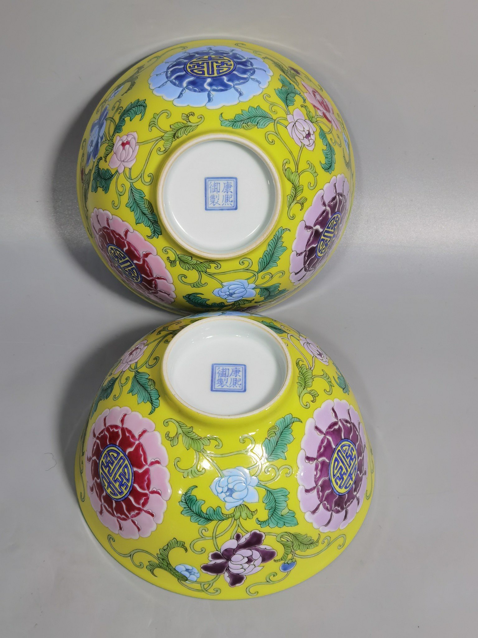 Qing Dynasty Kangxi Imperial enamel bowl with flowers and longevity characters on the ground