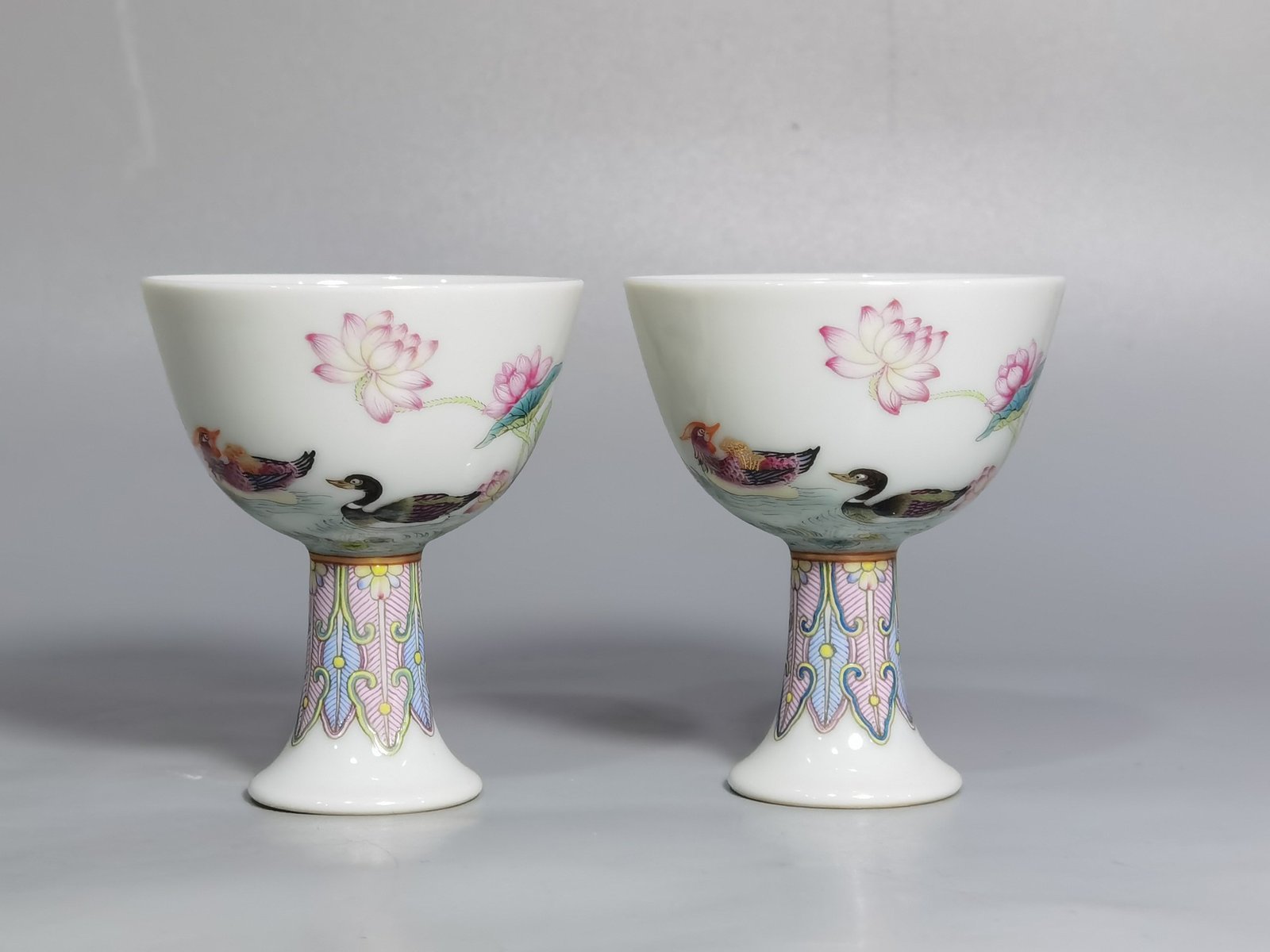 Qing Dynasty Yongzheng A pair of pastel mandarin duck and lotus goblets