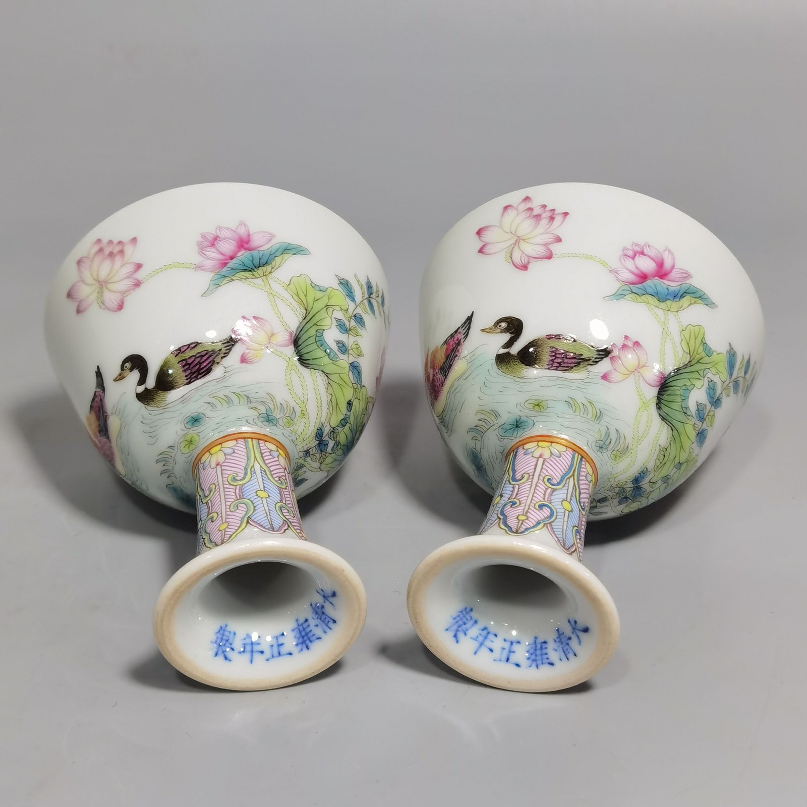 Qing Dynasty Yongzheng A pair of pastel mandarin duck and lotus goblets