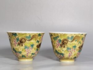 Qing Dynasty Yongzheng A pair of beige-glazed pastel squirrel-grape cups