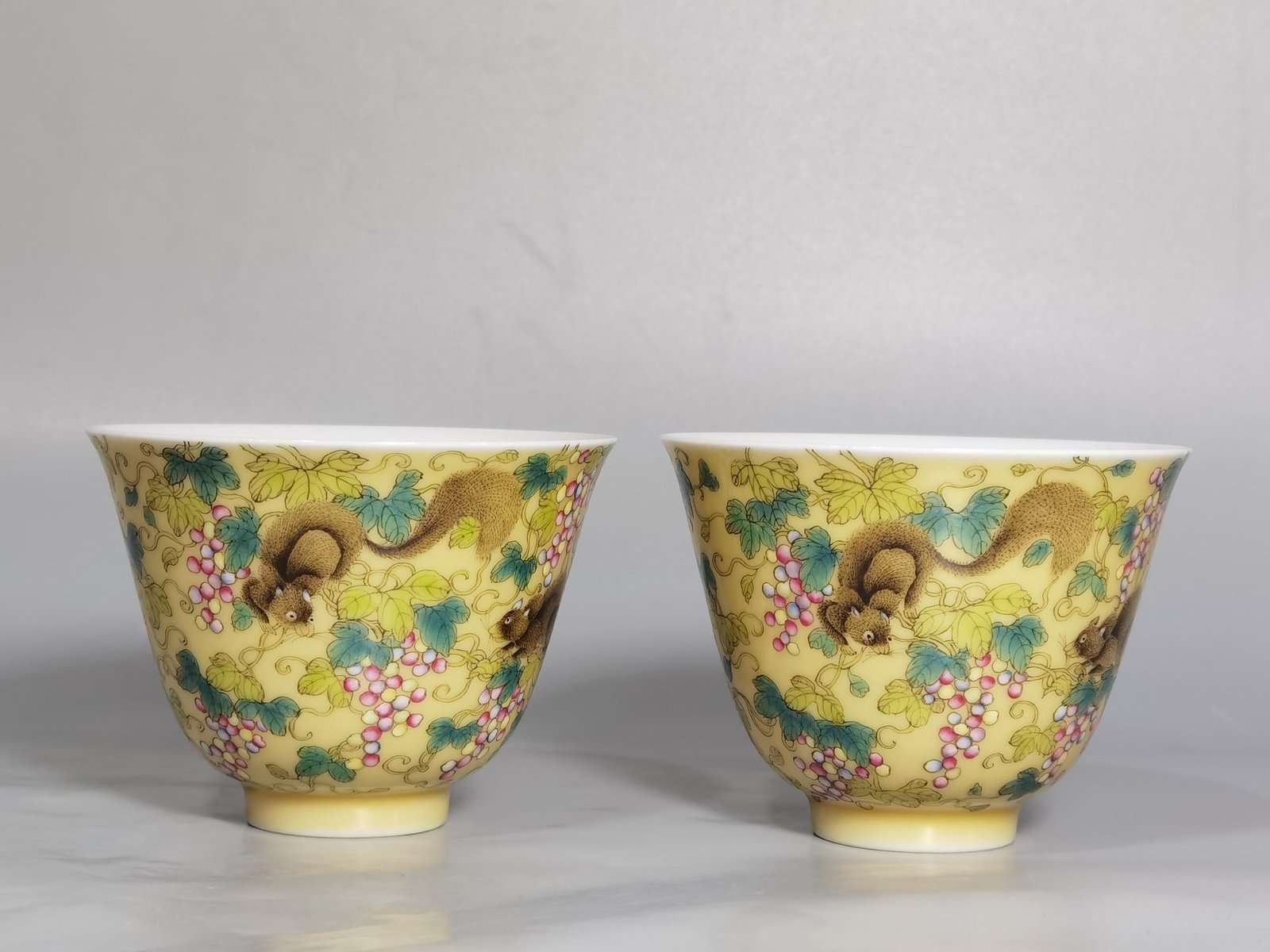 Qing Dynasty Yongzheng A pair of beige-glazed pastel squirrel-grape cups