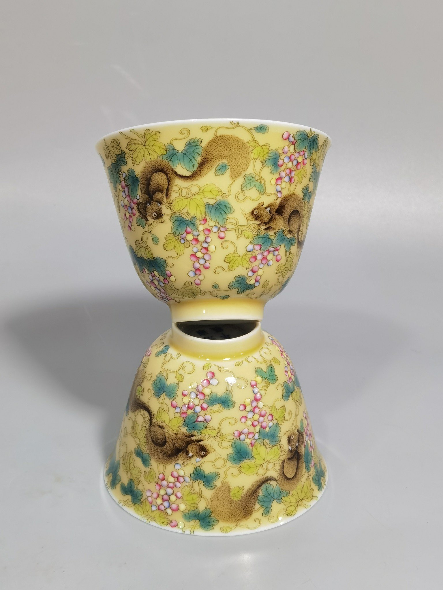 Qing Dynasty Yongzheng A pair of beige-glazed pastel squirrel-grape cups