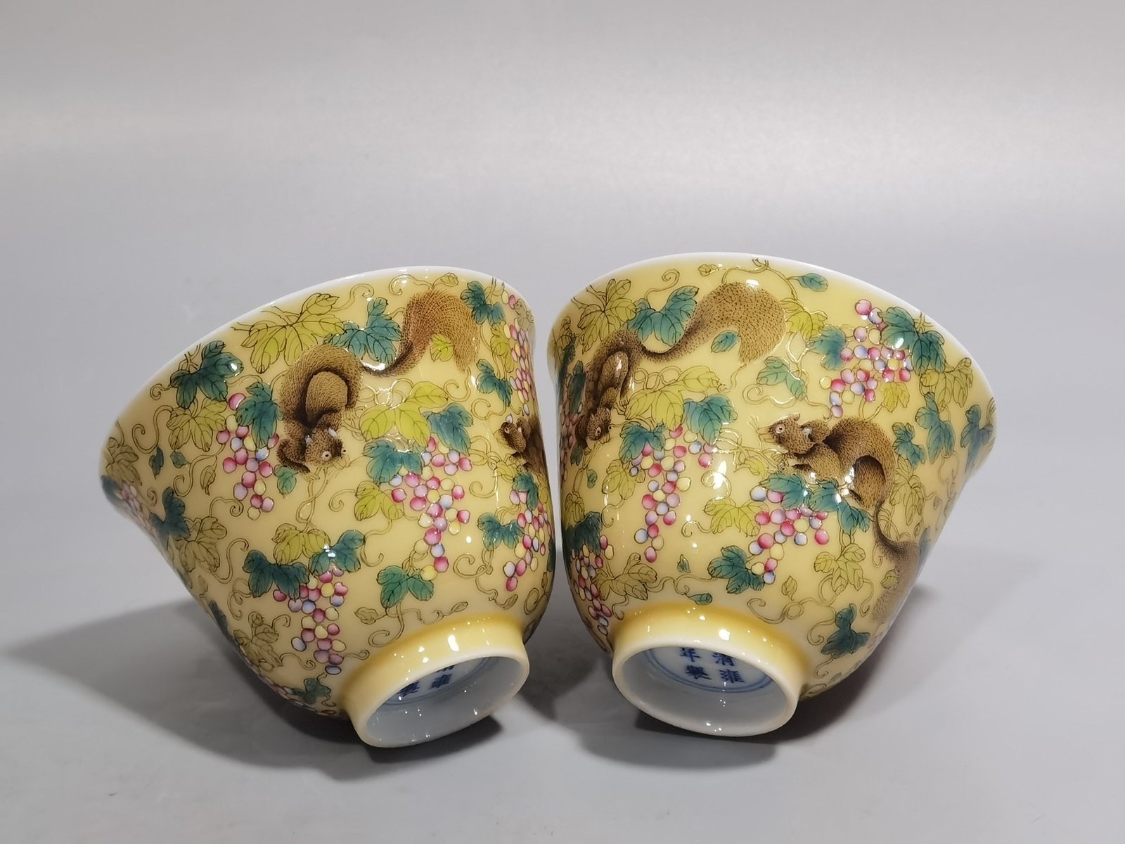 Qing Dynasty Yongzheng A pair of beige-glazed pastel squirrel-grape cups
