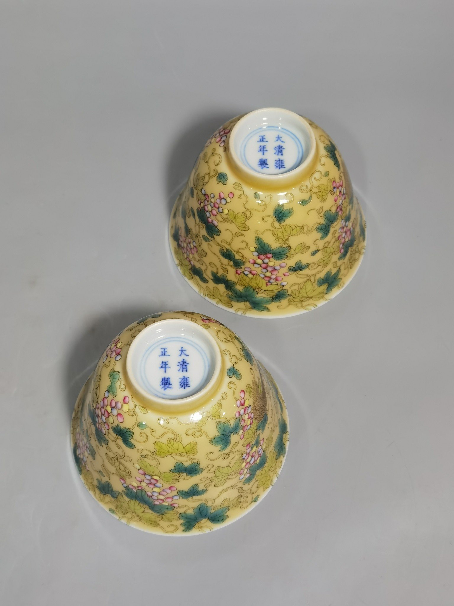 Qing Dynasty Yongzheng A pair of beige-glazed pastel squirrel-grape cups
