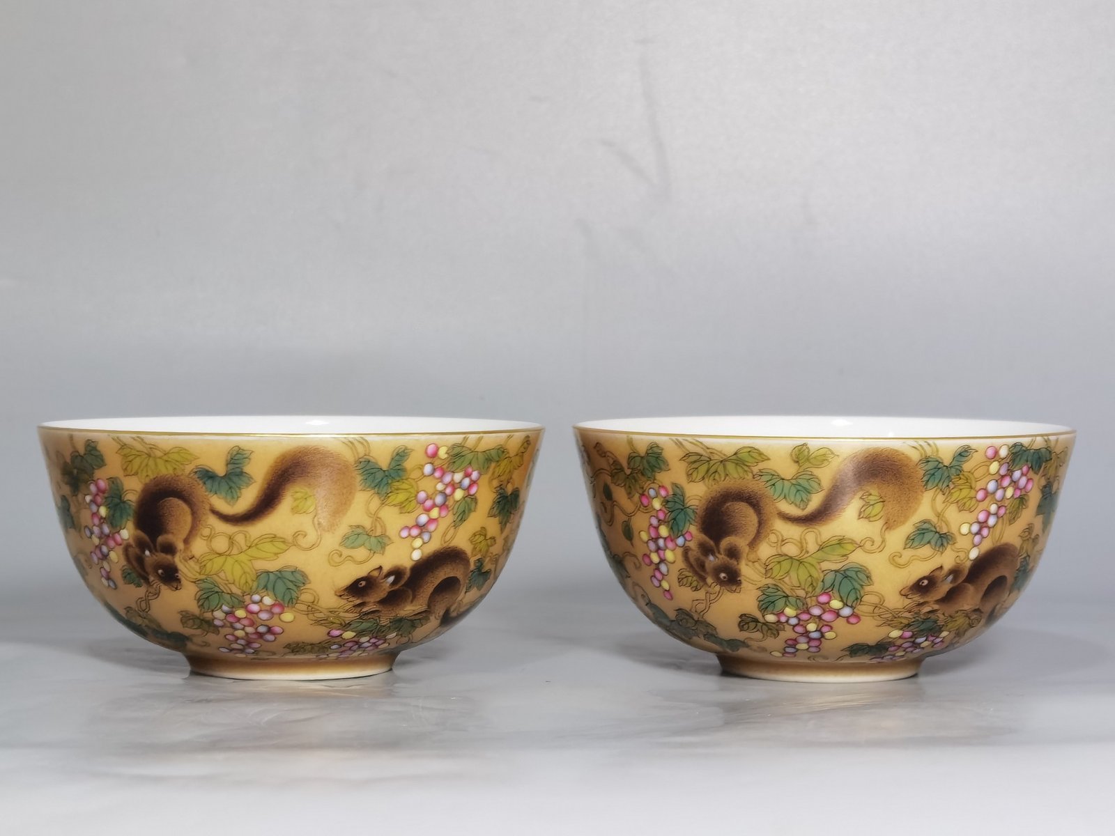 Qing Dynasty Yongzheng A pair of beige-glazed pastel squirrel-grape cups