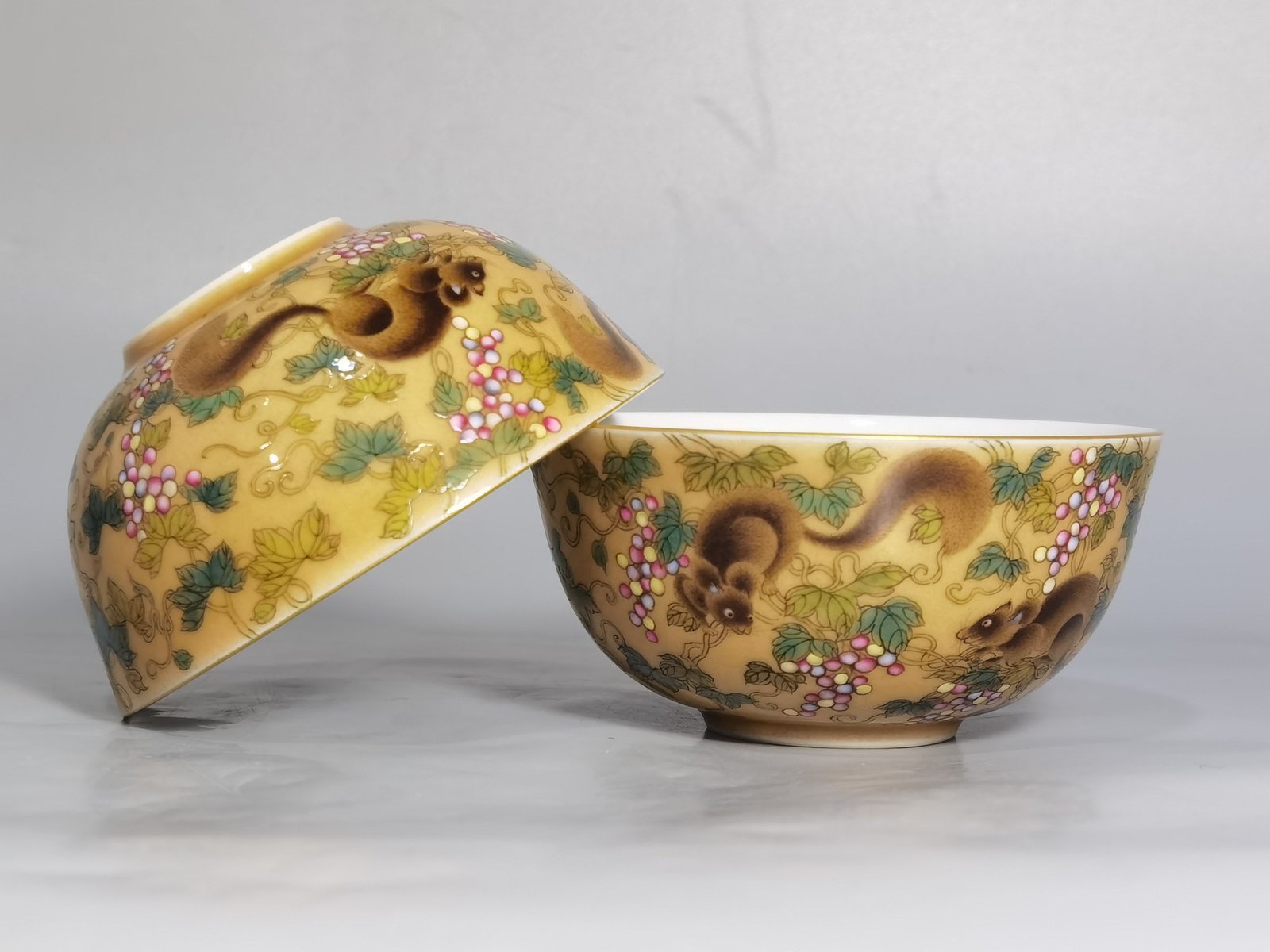 Qing Dynasty Yongzheng A pair of beige-glazed pastel squirrel-grape cups