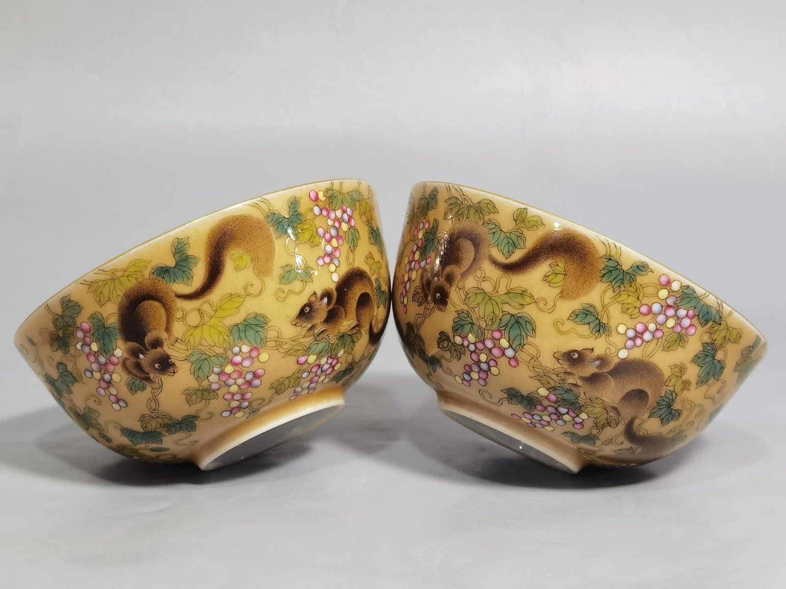 Qing Dynasty Yongzheng A pair of beige-glazed pastel squirrel-grape cups