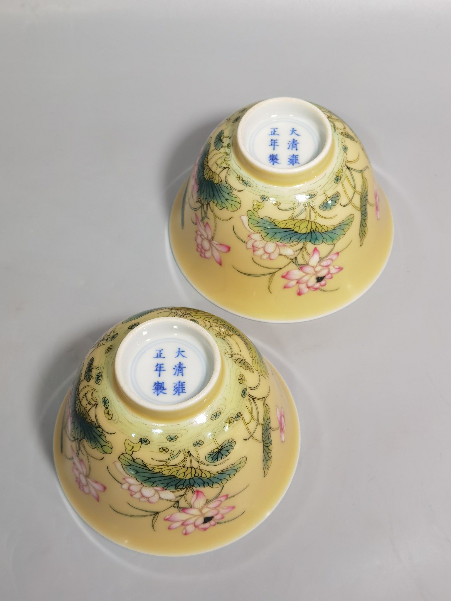 Qing Dynasty Yongzheng A pair of beige-glazed pastel mandarin duck and lotus cups