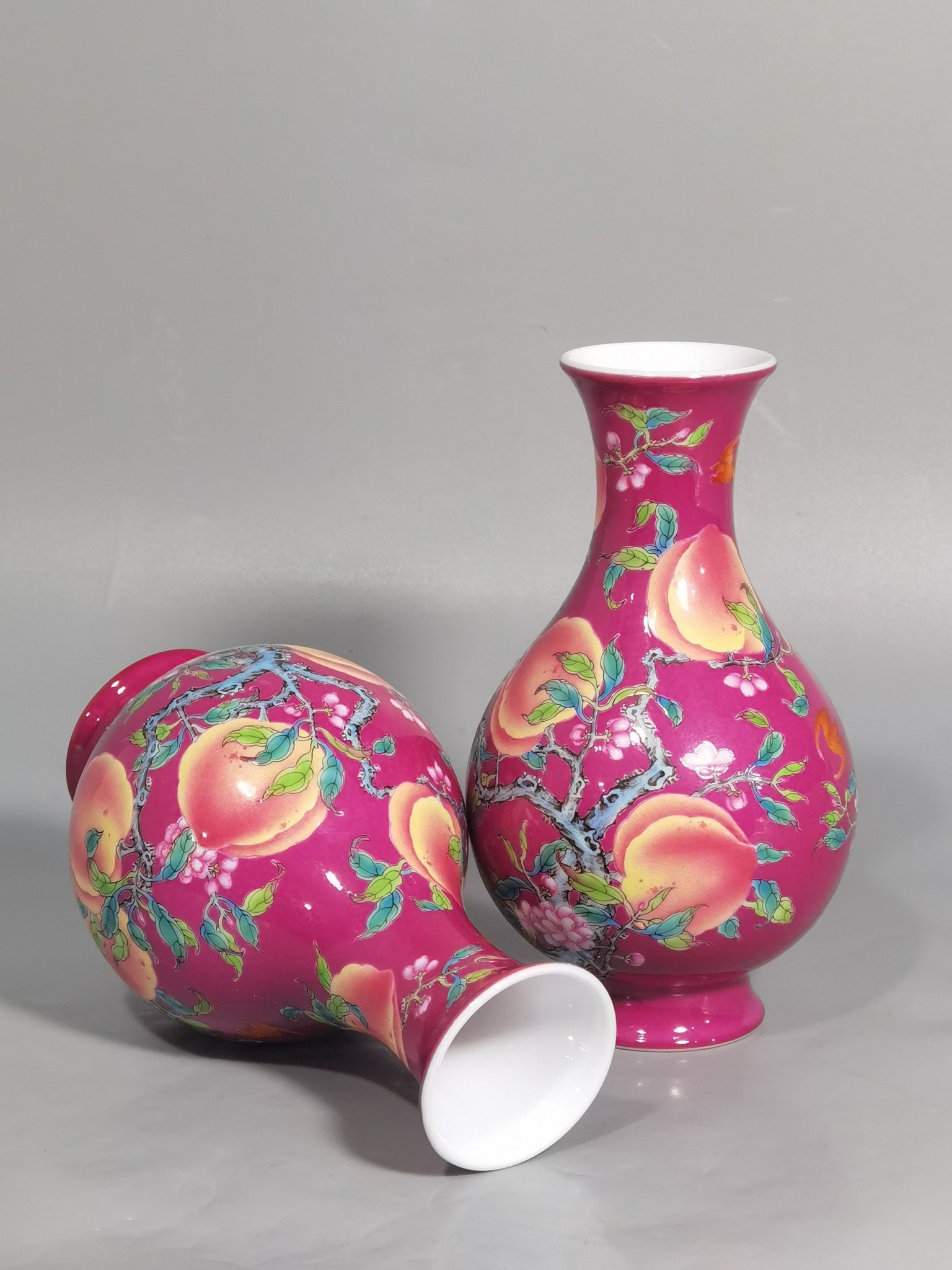 Qing Dynasty Yongzheng A pair of rouge ground pastel eight peach and five blessing vases during