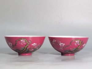Qing Dynasty Yongzheng a pair of rouge ground pastel plum and bamboo spring tea balls