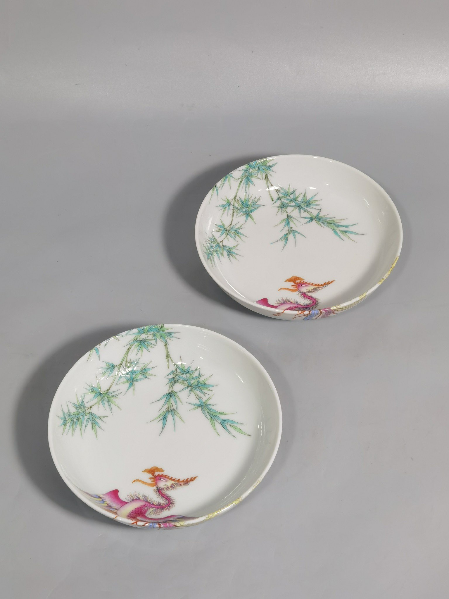 Qing Dynasty Yongzheng A pair of small platters with pastel-colored double phoenixes and green bamboo