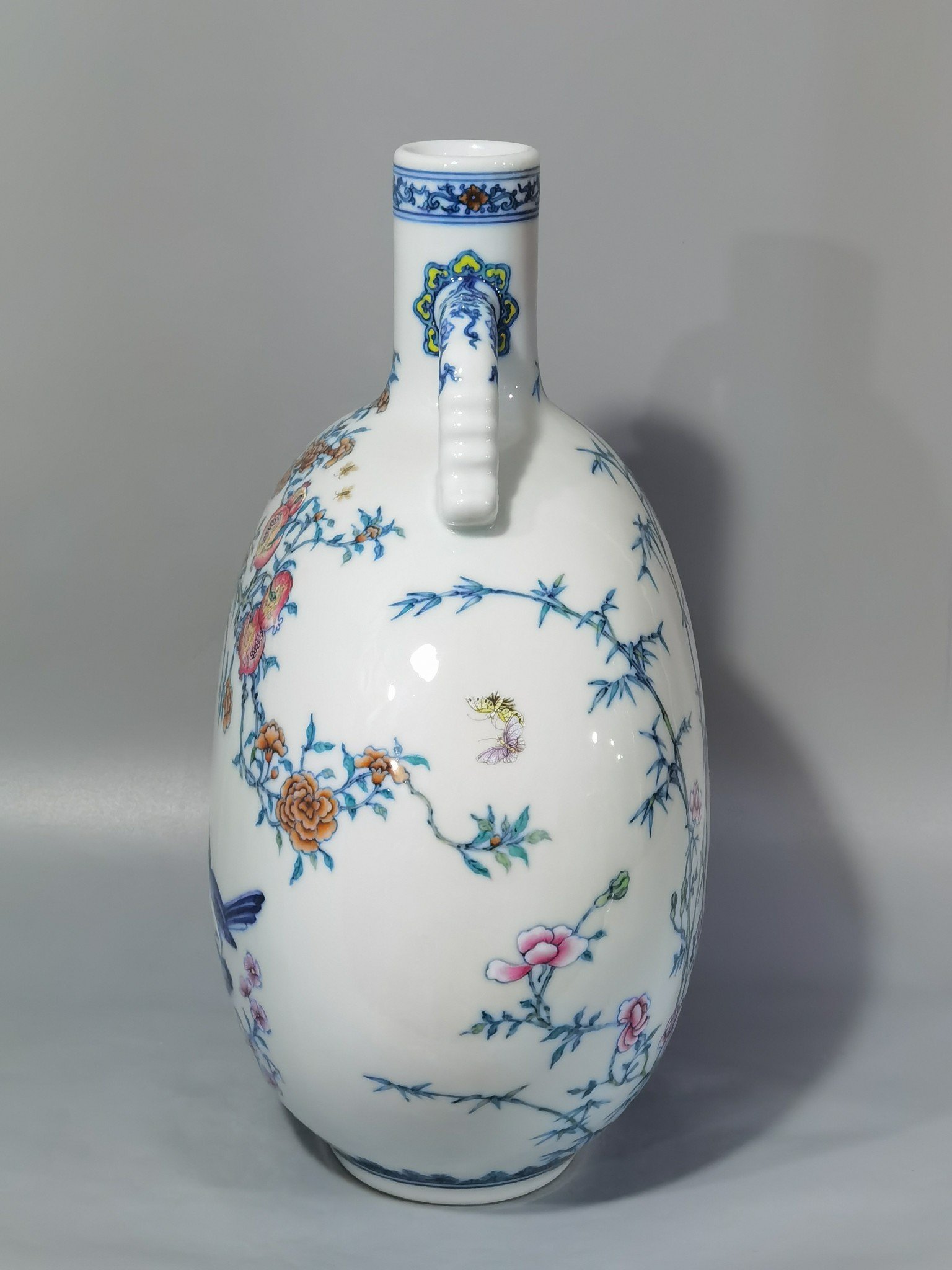 Qing Dynasty Yongzheng blue and white and pastel Anxi figure holding the moon flat vase