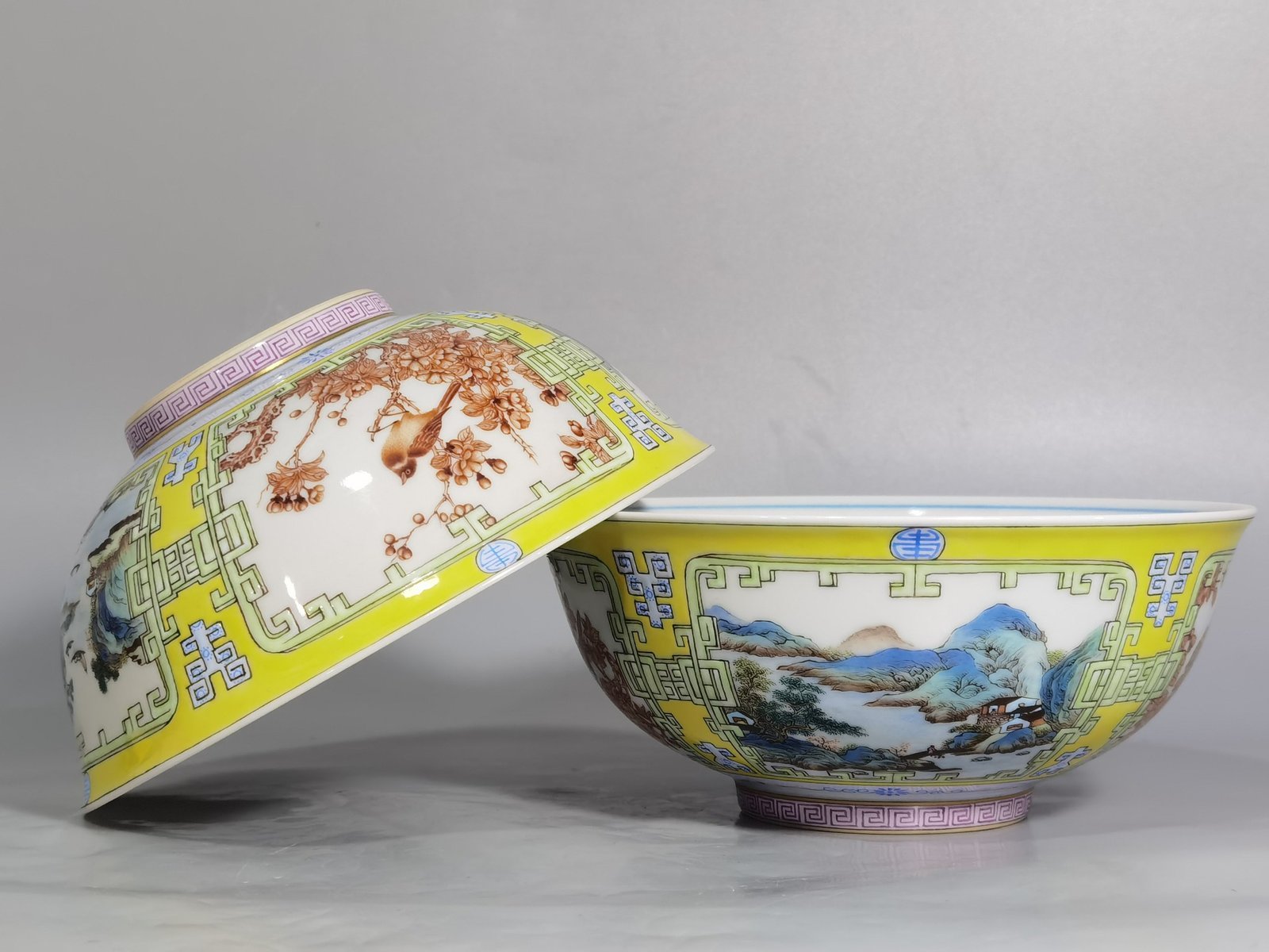 Qing Dynasty Yongzheng yellow ground pastel a pair of blue and white palace bowls with Cowherd
