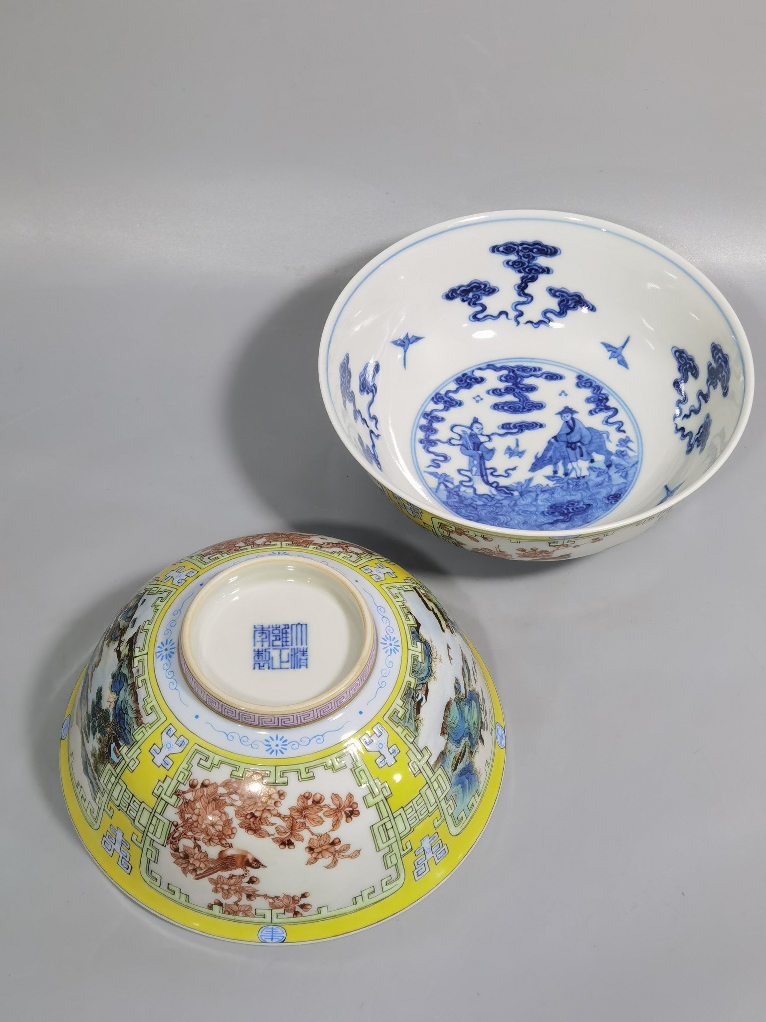 Qing Dynasty Yongzheng yellow ground pastel a pair of blue and white palace bowls with Cowherd