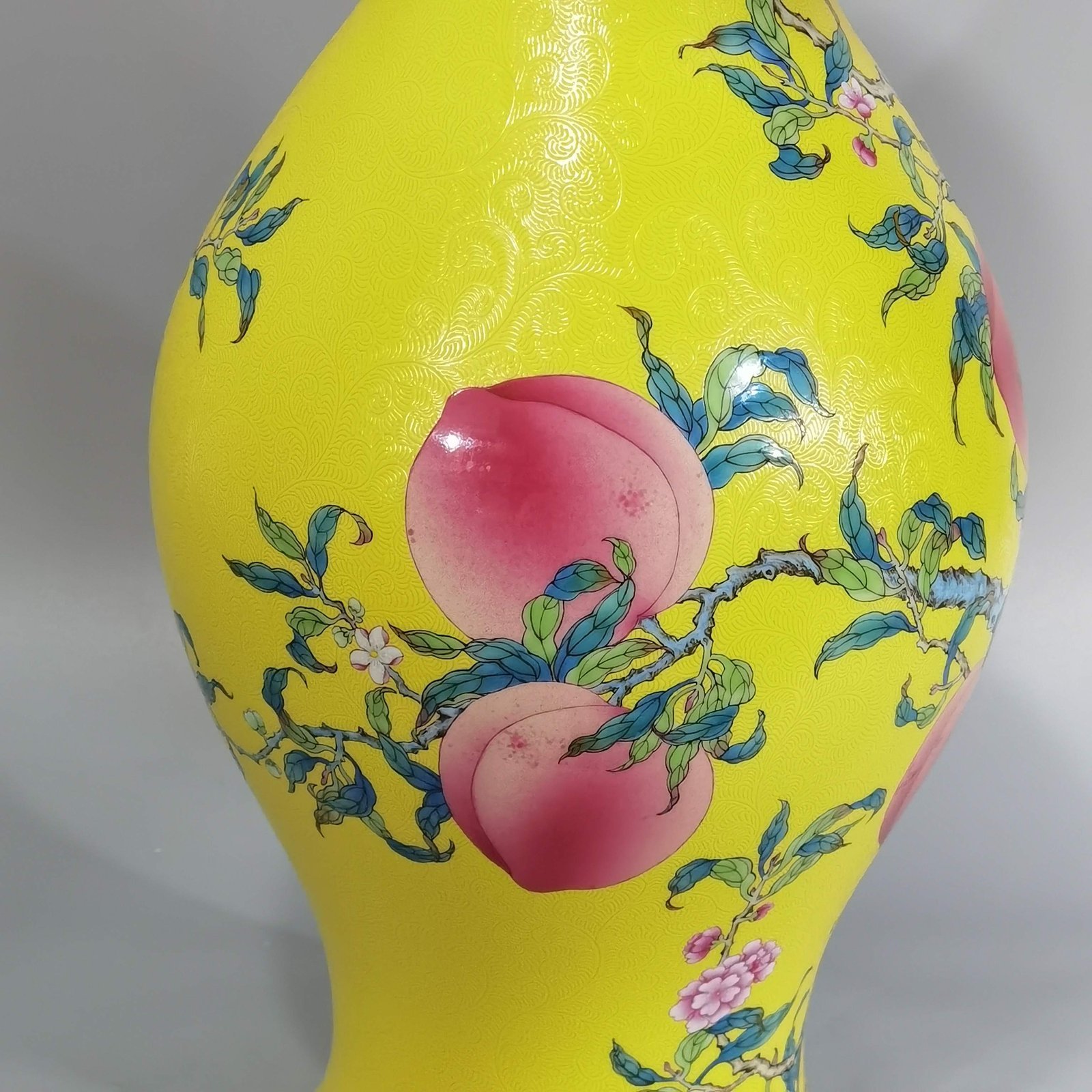 Qing Dynasty Yongzheng yellow ground rolling road pastel eight peaches and five blessings olive vase