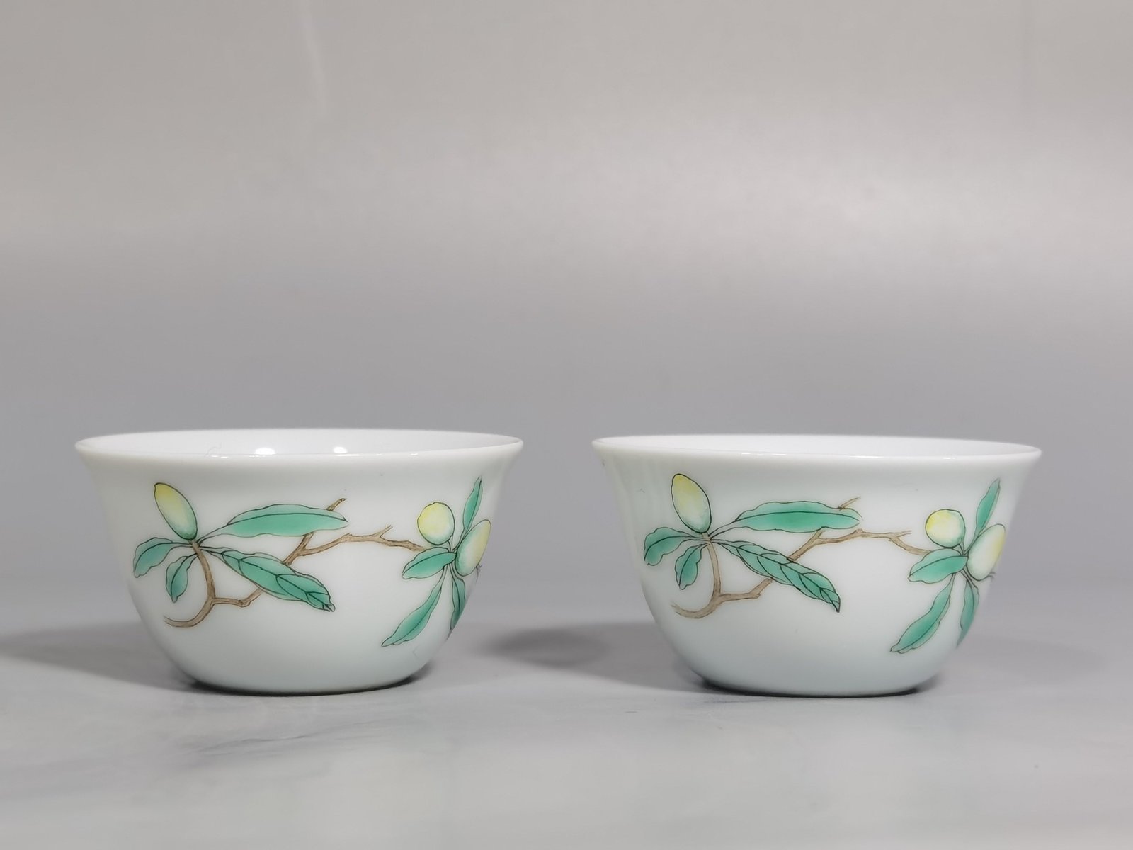 Qing Dynasty Yongzheng A pair of pastel flower and butterfly cups made during